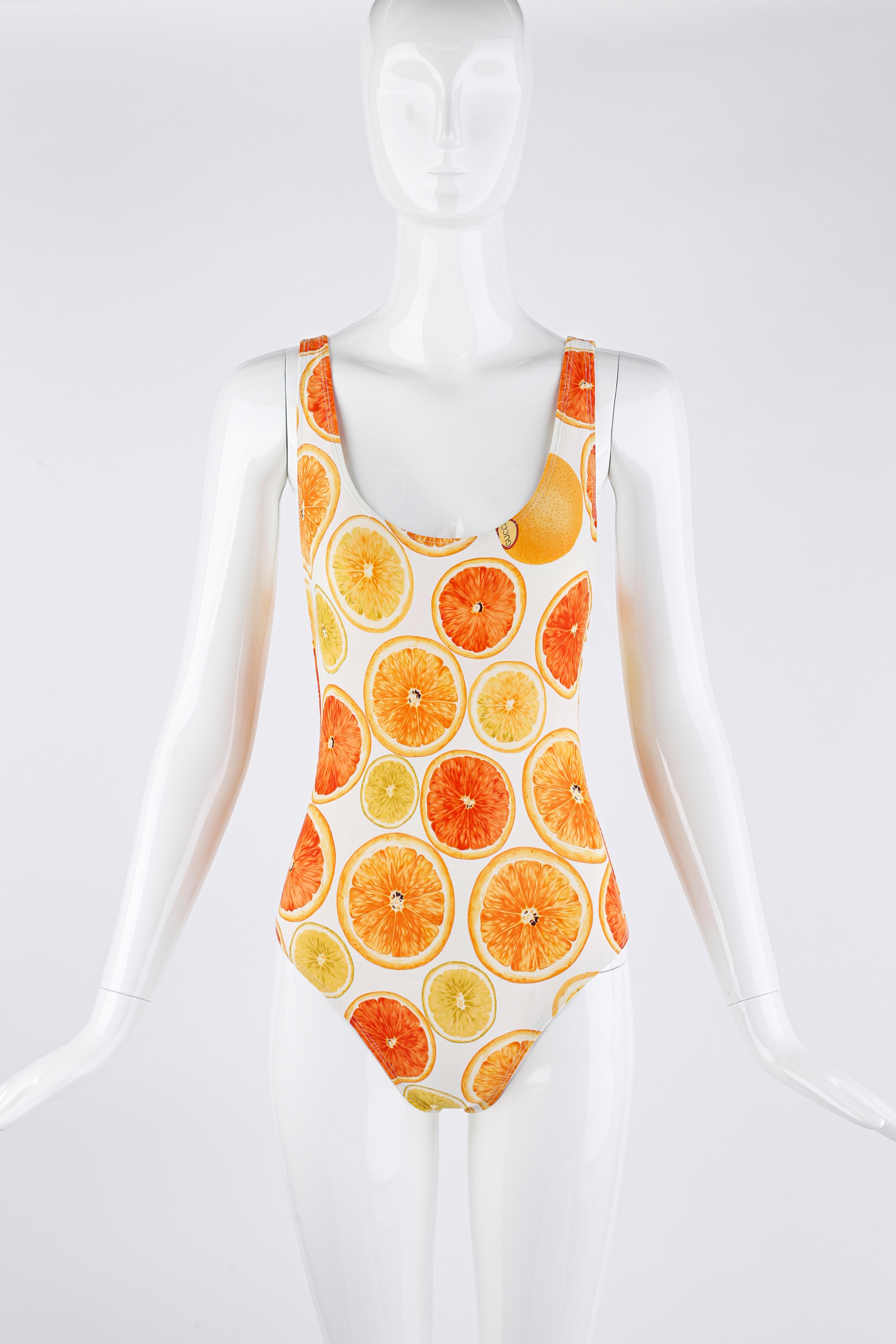 From Tom Ford's very first collection with Gucci for the Spring/Summer 1995 collection; this print was seen on the runway for that season. This very rare and stunning one-piece swimsuit features a collage of vibrant citrus fruits. Deep scoop front