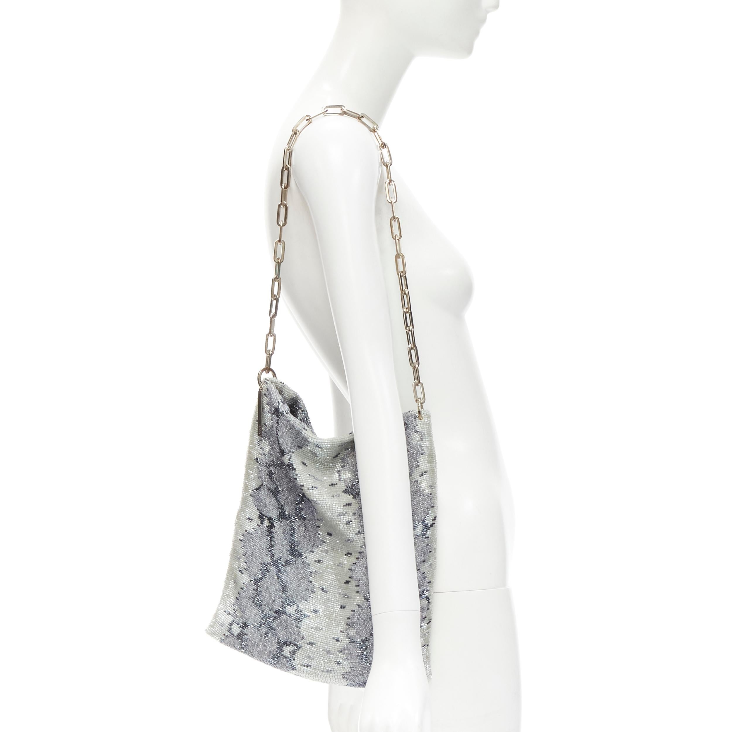 GUCCI TOM FORD Vintage blue grey python bead embellished silver chain bag
Brand: Gucci
Designer: Tom Ford
Model: 001 4328 2684
Material: Fabric
Color: Blue
Pattern: Animal Print
Closure: Open Top
Extra Detail: Grey and silver python design fully