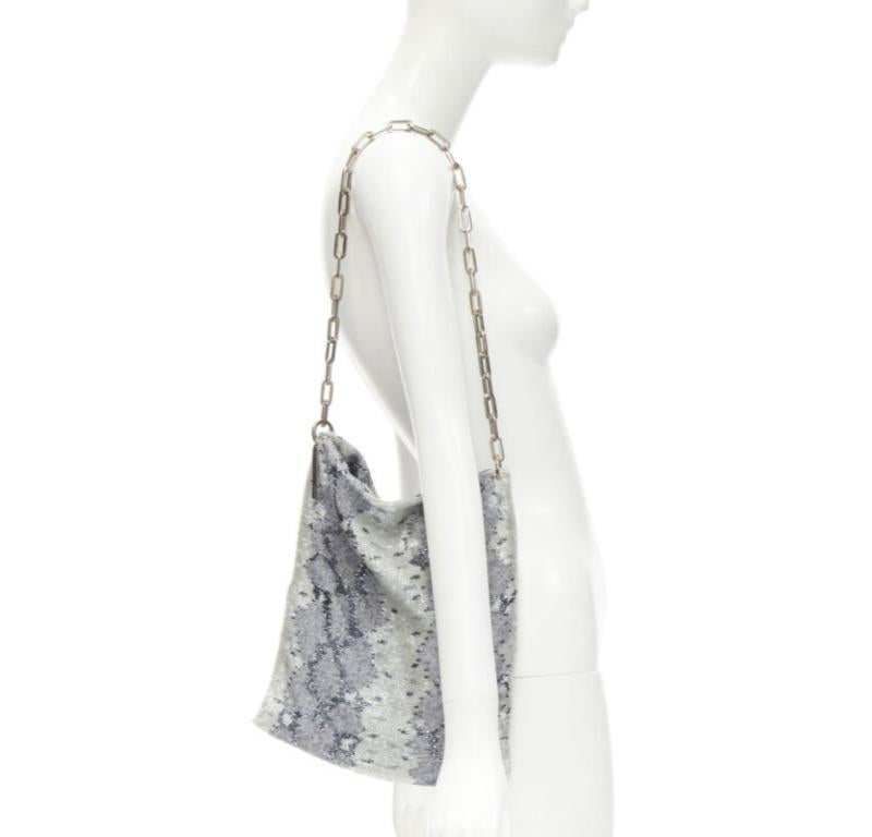 GUCCI TOM FORD Vintage blue grey scaled leather embellished silver chain bag
Reference: ANWU/A00903
Brand: Gucci
Designer: Tom Ford
Model: 001 4328 2684
Material: Fabric
Color: Blue, Grey
Pattern: Animal Print
Closure: Open Top
Lining:  Fabric
Extra