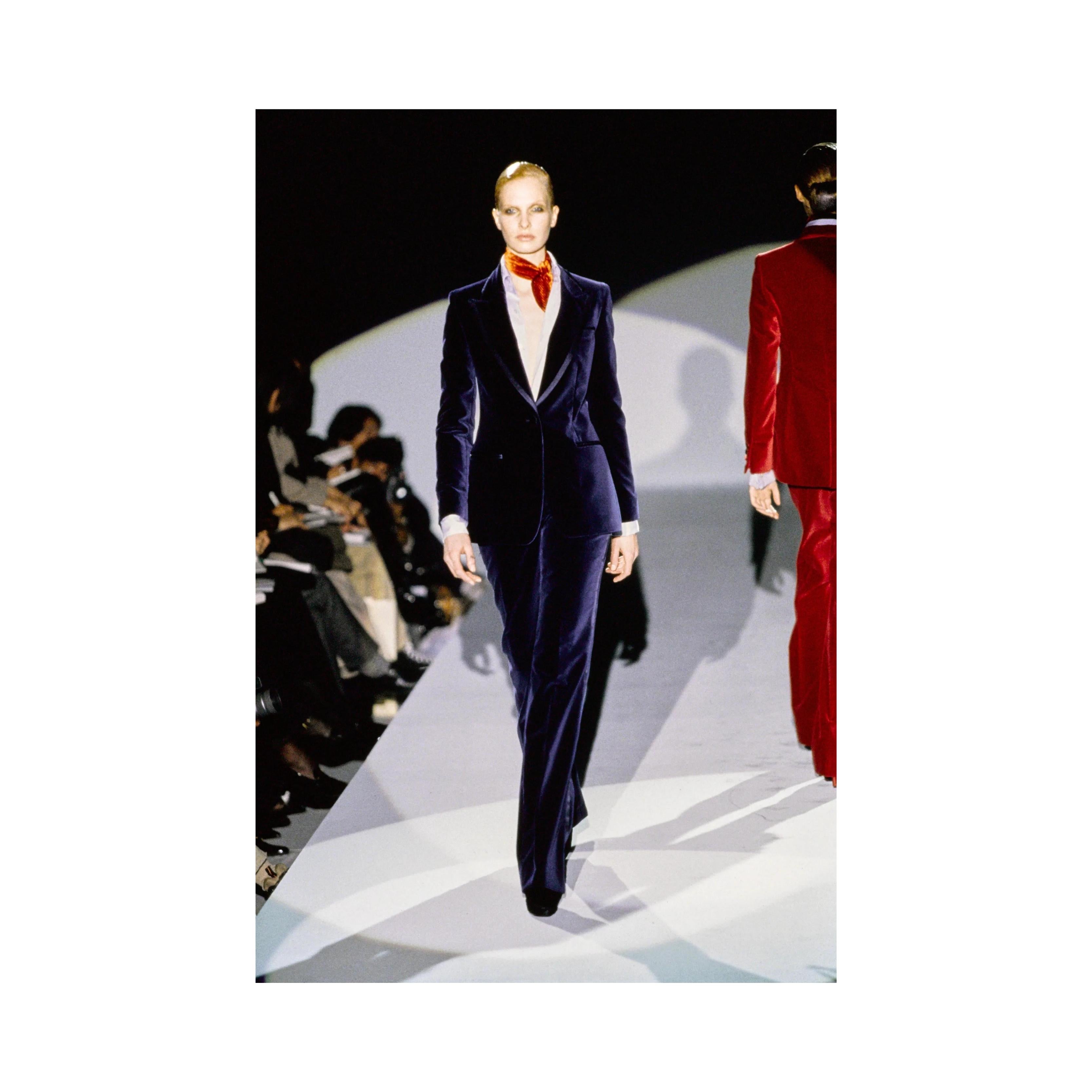 This luxurious Gucci blazer is crafted from blue viscose velvet with lustrous silk trimmings. The structured silhouette features a lapel collar with silk hems and fabric-covered buttons on the sleeve cuffs. This statement piece is from Tom Ford's