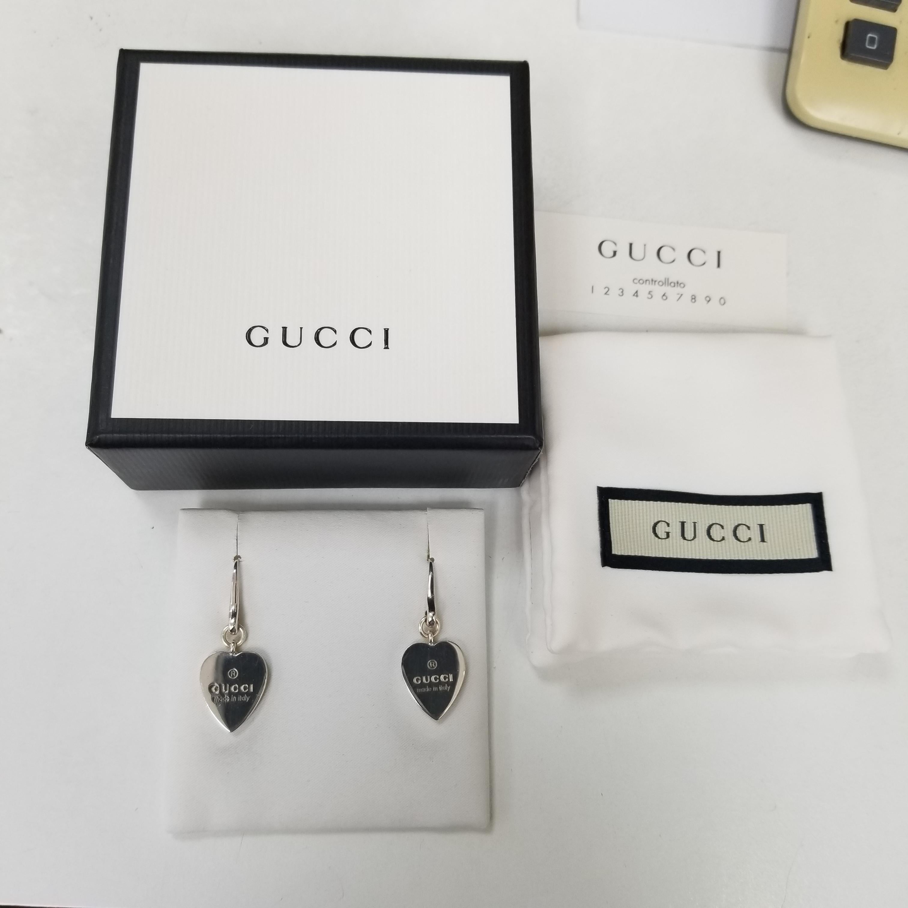 Gucci trademark heart charm drop dangle earrings. Elegant chic design made of solid SS.925 sterling silver.  Handcrafted design stamped made in Italy on back with logo on front. Hangs a little under 1.5”. There is a fab heart dangle ring listed in