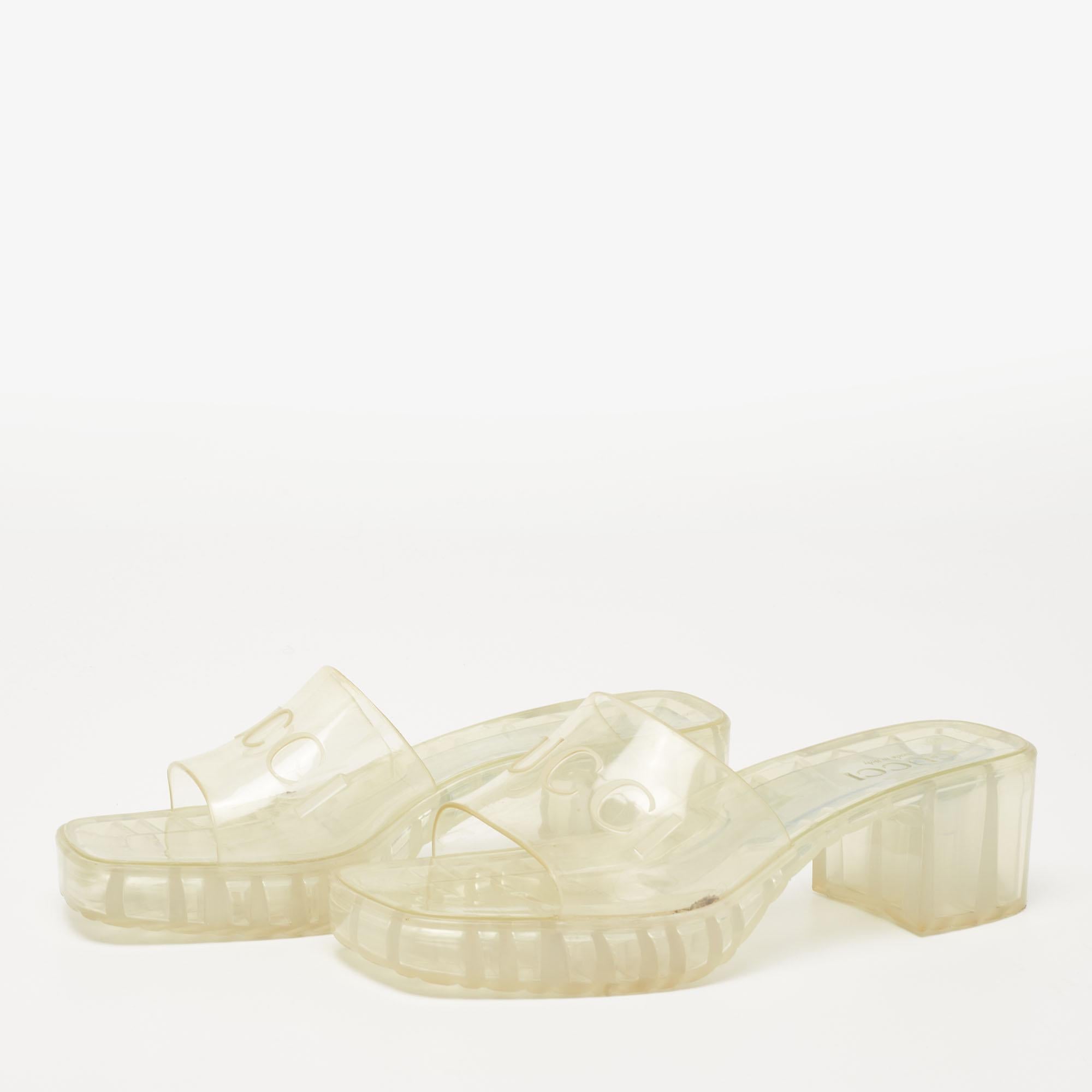 Made in Italy, these fun Gucci slides are a playful take on a staple style. Crafted from rubber, the slides feature the embossed Gucci logo, open toes, and chunky heels. The transparent pair projects a retro appeal along with being water-resistant.