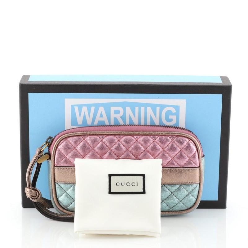 This Gucci Trapunata Wristlet Quilted Laminated Leather, crafted in laminated multicolor metallic leather, a wristlet strap and gold-tone hardware. Its zip closure opens to a red print fabric interior. 

Estimated Retail Price: $950
Condition: