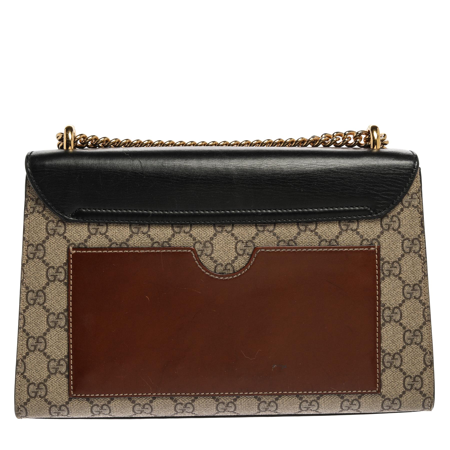 Made with GG Supreme canvas and premium quality leather, this Gucci Padlock can be used both as a crossbody and a shoulder bag. It is held by a sleek gold-tone chain and adorned with a gold-tone key-lock closure on the front. Carry this beauty for
