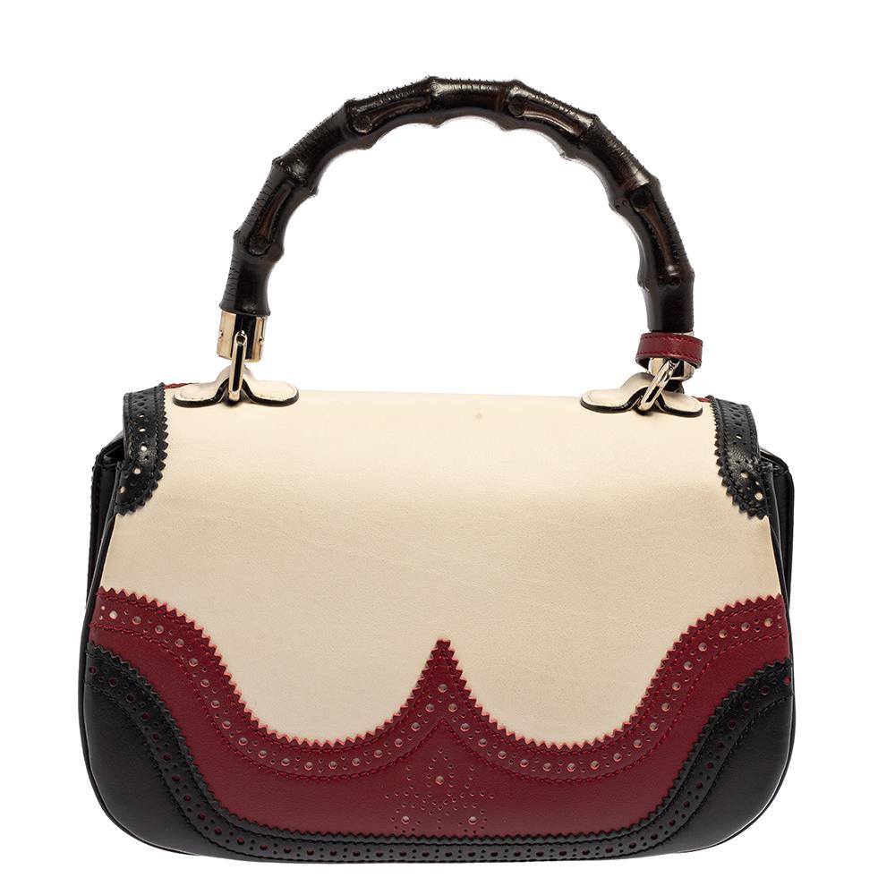 Bags from Gucci are on every woman's wishlist. So, own this gorgeous limited edition bag today and light up your closet! Crafted from leather, this fabulous brogue detailed tricolored number has a front flap that is detailed with the signature