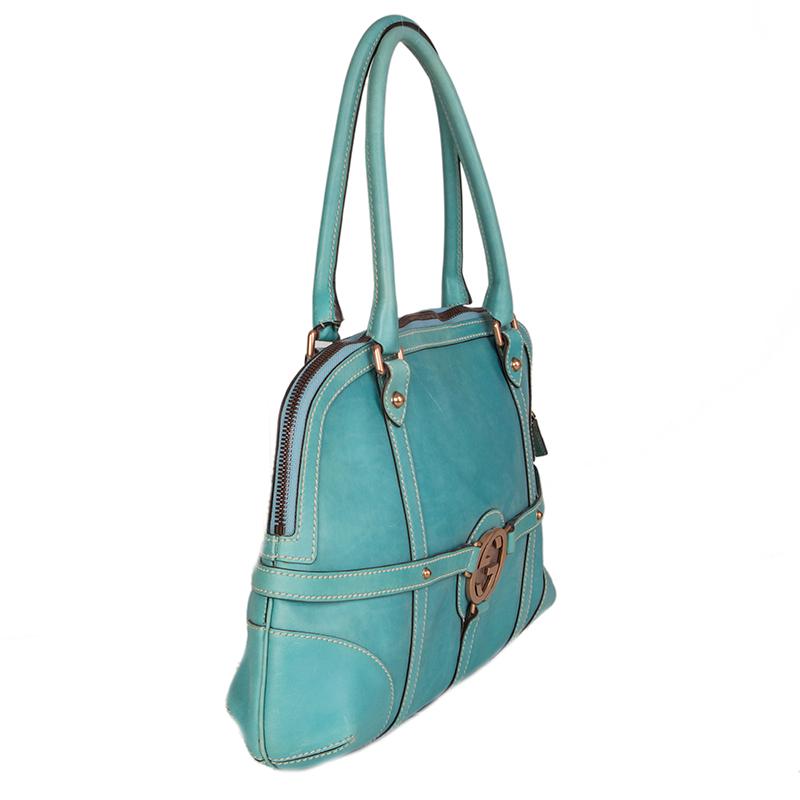 Gucci 'GG' shoulder bag in turquoise leather featuring 'GG' logo in bronze-metal. Opens with a zipper on top and is lined in dark brown canvas with a zipper pocket against the back. Has been carried and some soft color-fading allover the bag.