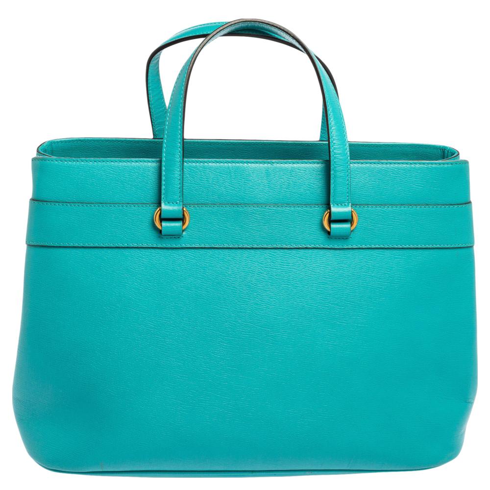 This Bright Bit tote from Gucci proves that style can come in simple things too. Crafted from leather, this lovely turquoise bag features a canvas-lined interior, two top handles, and a long detachable shoulder strap. It is equipped with gold-tone