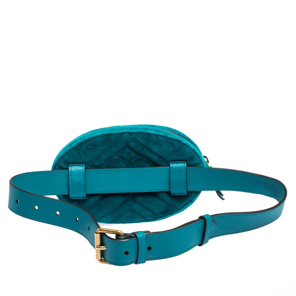 This Gucci Marmont bag has been exquisitely crafted in Italy and made from turquoise velvet featuring the signature Matelasse pattern all over. It is equipped with a luxurious satin interior that is secured with zip closure. On the front, there is