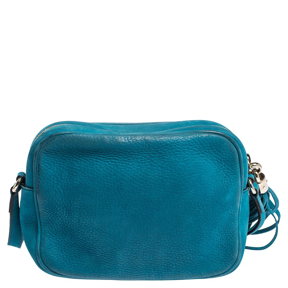 Fancy bags are a wardrobe must-have. Made in Italy, this Soho Disco bag by Gucci has been crafted out of turquoise nubuck leather, lined with canvas on the insides and sized to fit in your essentials. It has gold-tone hardware, top zip closure with