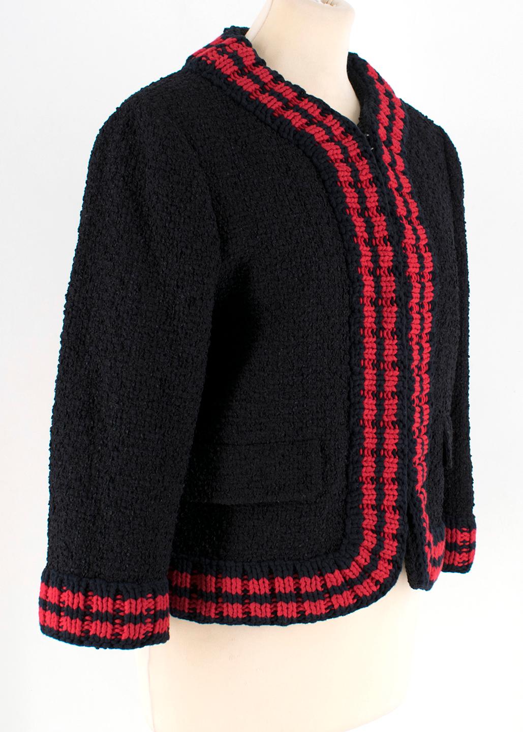 Gucci Tweed Jacket With Knit Red Trim

- Wool-blend tweed jacket.
- Trimmed with contrasting red and navy knit.
- Cropped style in a mid-weight material.
- Embroidered heart accent on lining. 
- Hook and eye fastening down centre.
- Flap pockets at