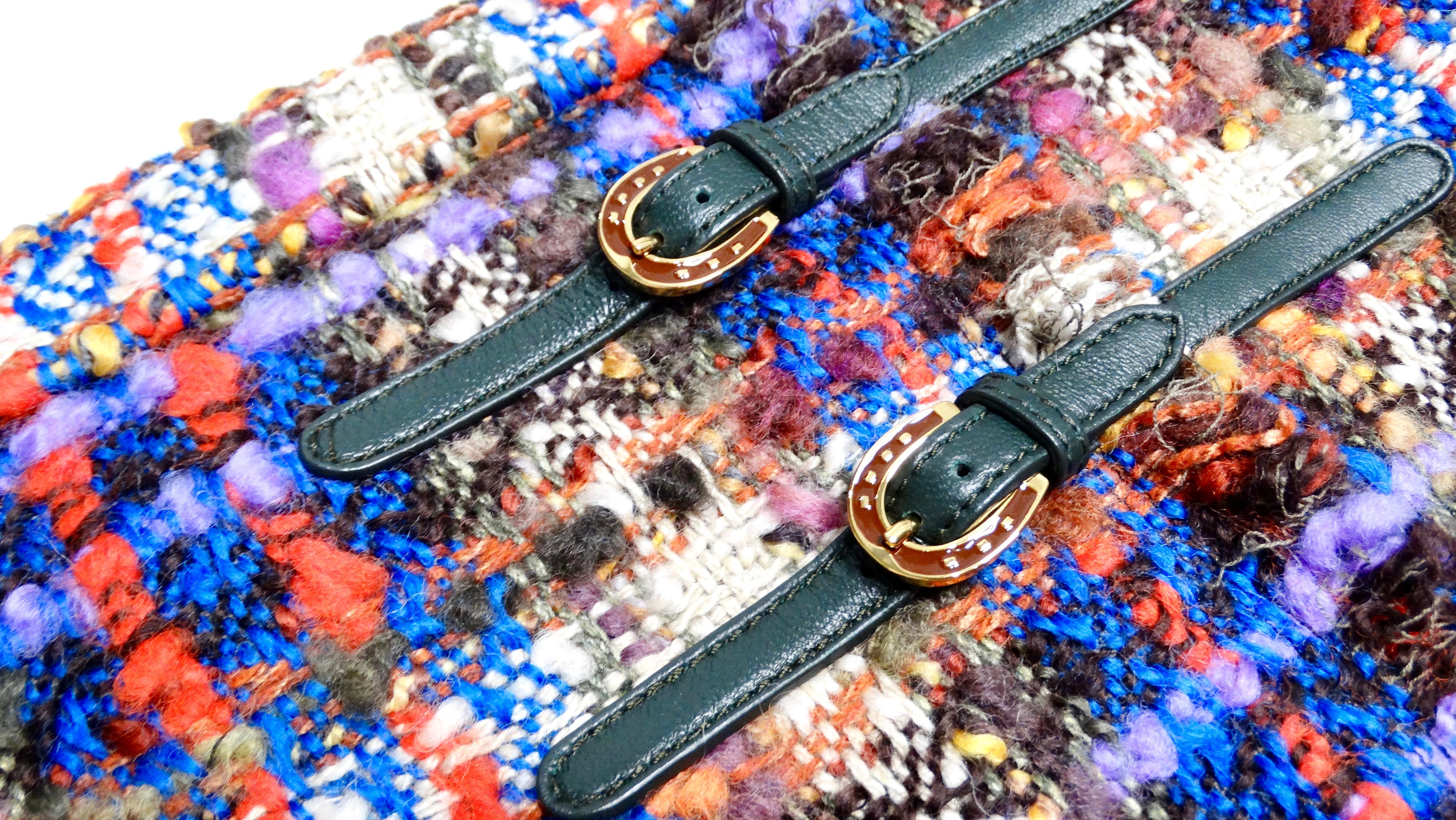 The Gucci Tweed Multicolor Plaid Frayed Skirt encapsulates the vibrant essence of autumn with its rich palette of orange, blue, purple, cream, and green. This captivating piece showcases a unique blend of hues that evoke the warmth of the season,