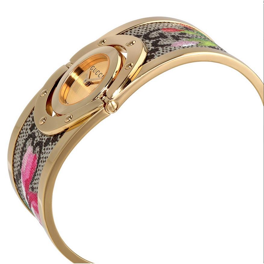 Gucci Twirl Bloom Gold Twirling Dial Gold-plated and Floral Women's Watch.
Dial Type: Analog
Dial Color: Gold Twirling
Crystal: Scratch Resistant Sapphire
Hands: Yellow Gold-tone
Bezel: Fixed
Bezel Material: Stainless Steel
Case Back: Solid
Case