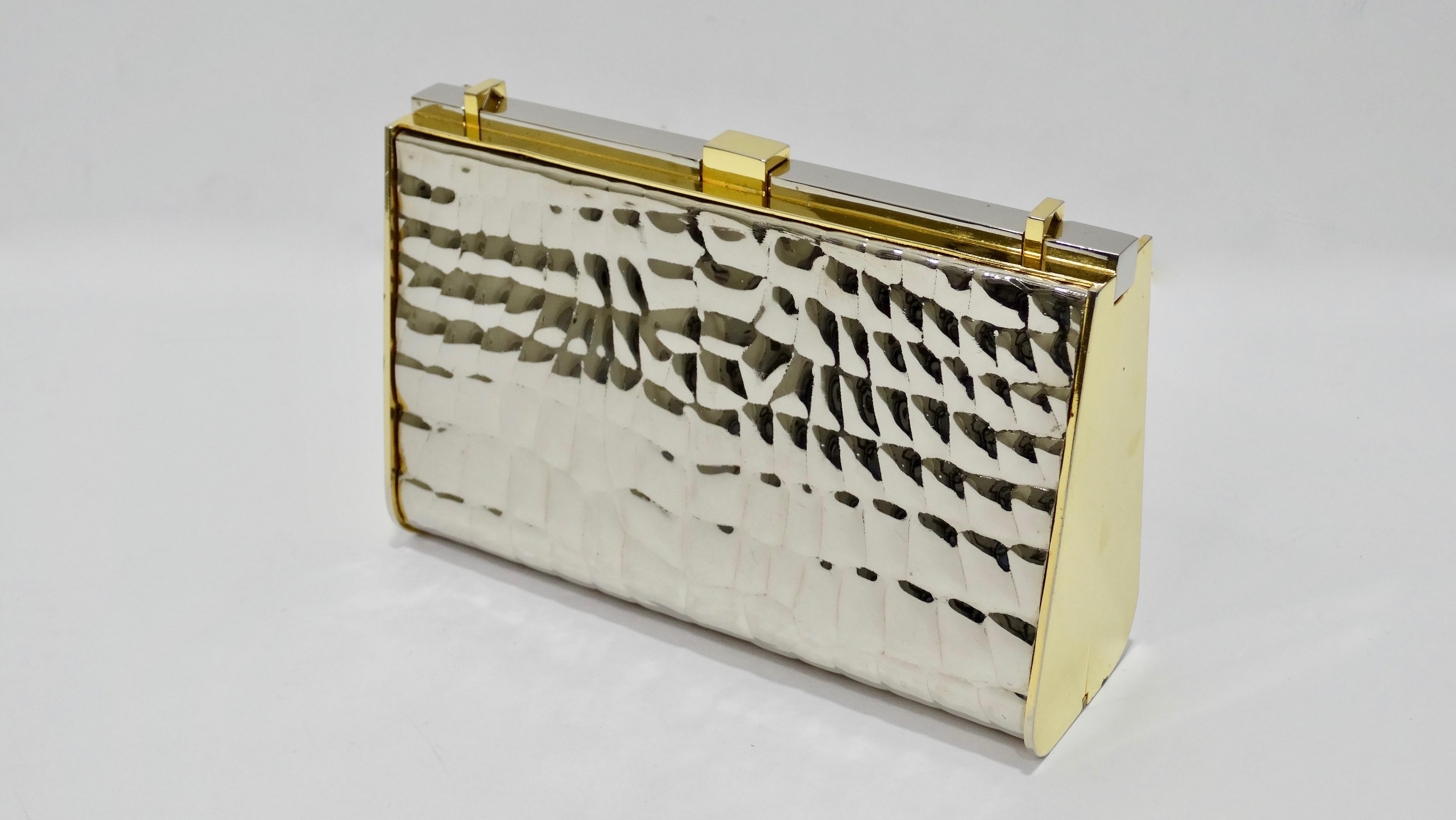 Now that'd what we call vintage! Circa late 20th-century, this rare crocodile embossed Gucci clutch is two-tone silver/gold plated and features a removable leather shoulder strap, a press button top closure and a matching croc embossed compact