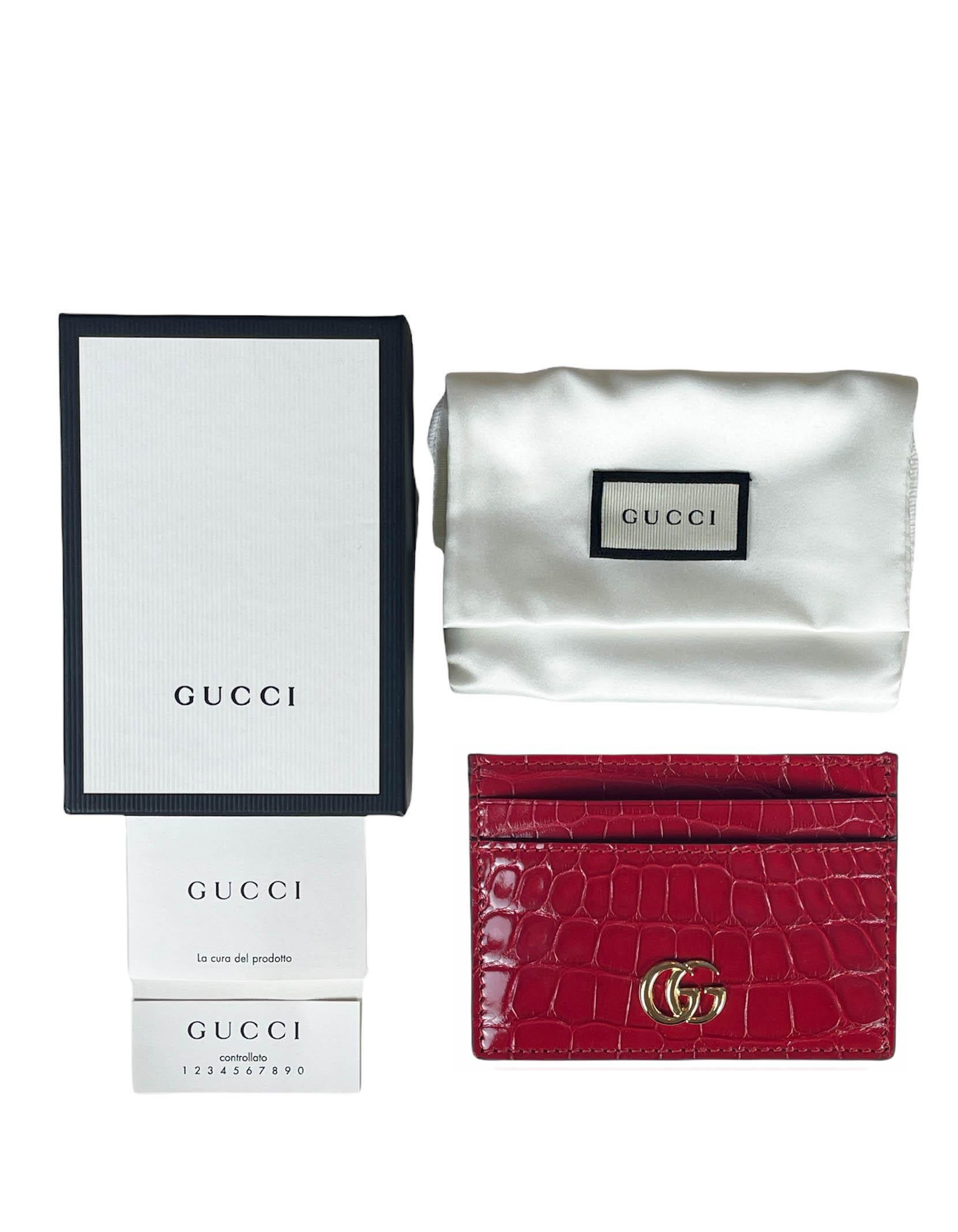 Gucci Red Alligator GG Marmont Card Case

Made In: Italy
Color: Red
Hardware: Goldtone
Materials: Alligator skin
Lining: Black leather
Closure/Opening: Slide in
Pockets: Five credit card slots
Condition: Like new
Includes: Gucci box, dustbag, care