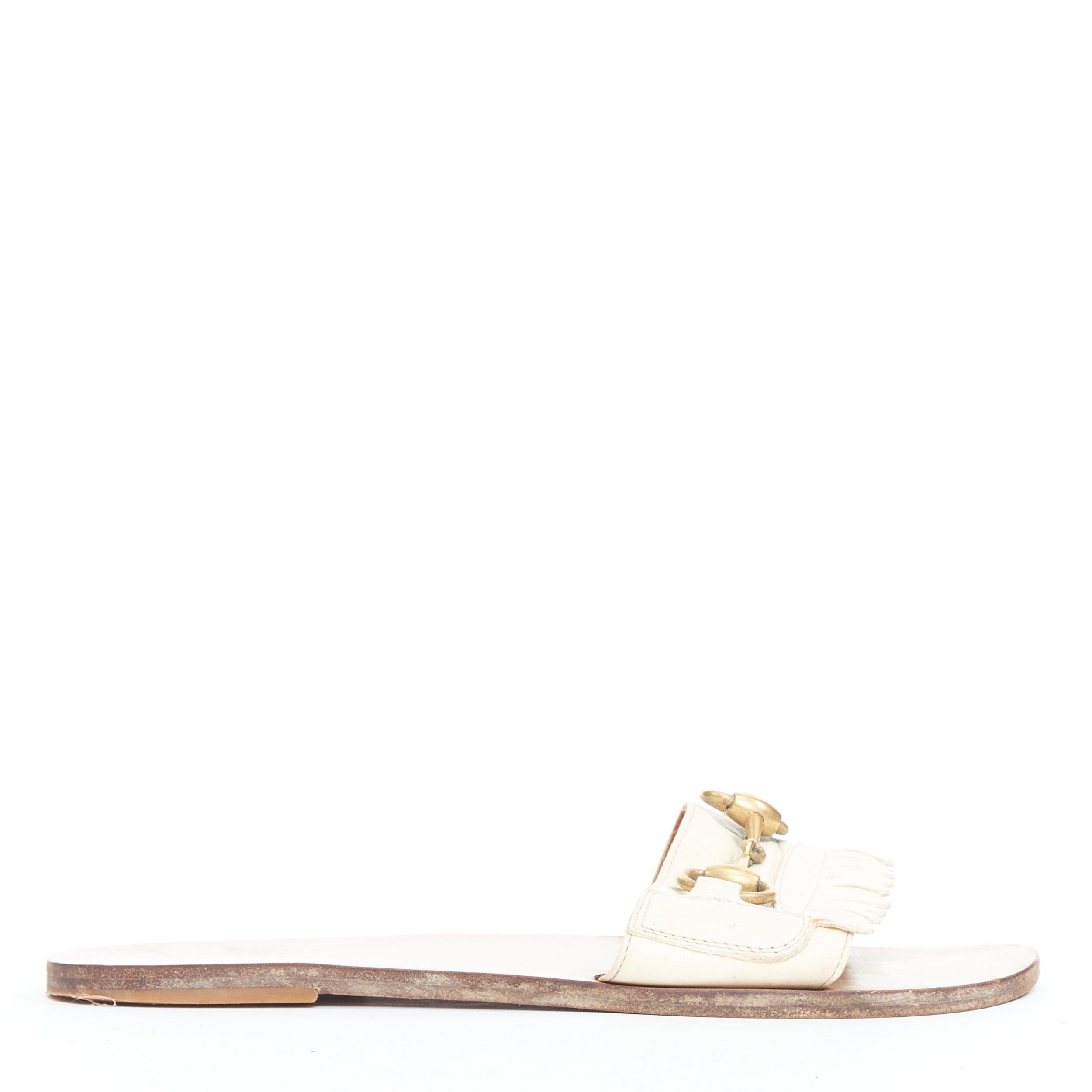 GUCCI Varadero cream gold horsebit fringe flat slipper shoes EU36.5
Reference: JACG/A00222
Brand: Gucci
Designer: Alessandro Michele
Model: Varadero
Material: Leather
Color: Cream, Gold
Pattern: Solid
Closure: Slip On
Lining: Brown Leather
Made in: