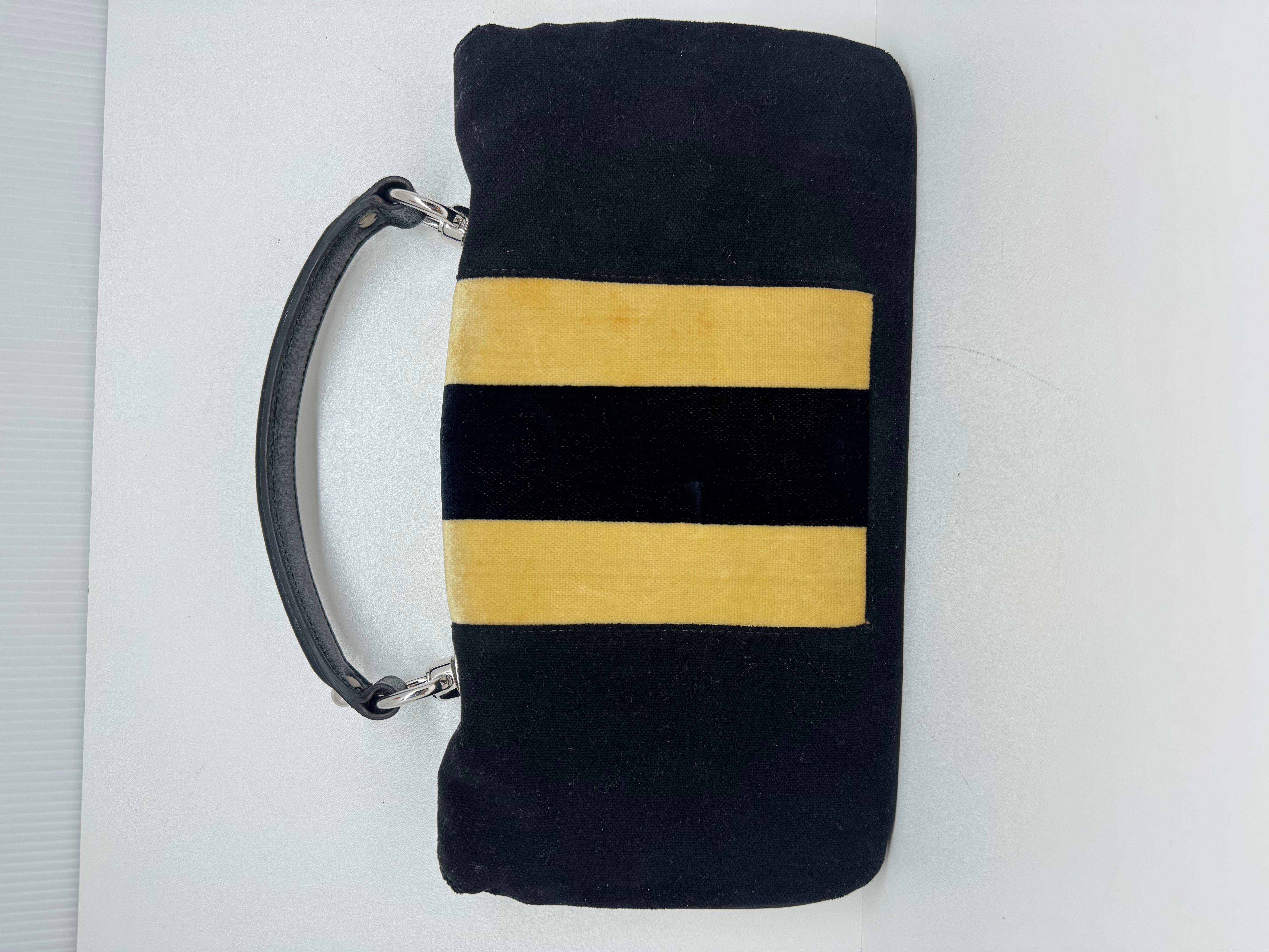 Gucci velour stripe top handle clutch bag. Pretty large size. Luxurious black and off white (almost beige like) tone. Perfect for formal wear. Minor tarnishing on the hardware. Visible nail marks on the yellow velvet surface. Comes as is.