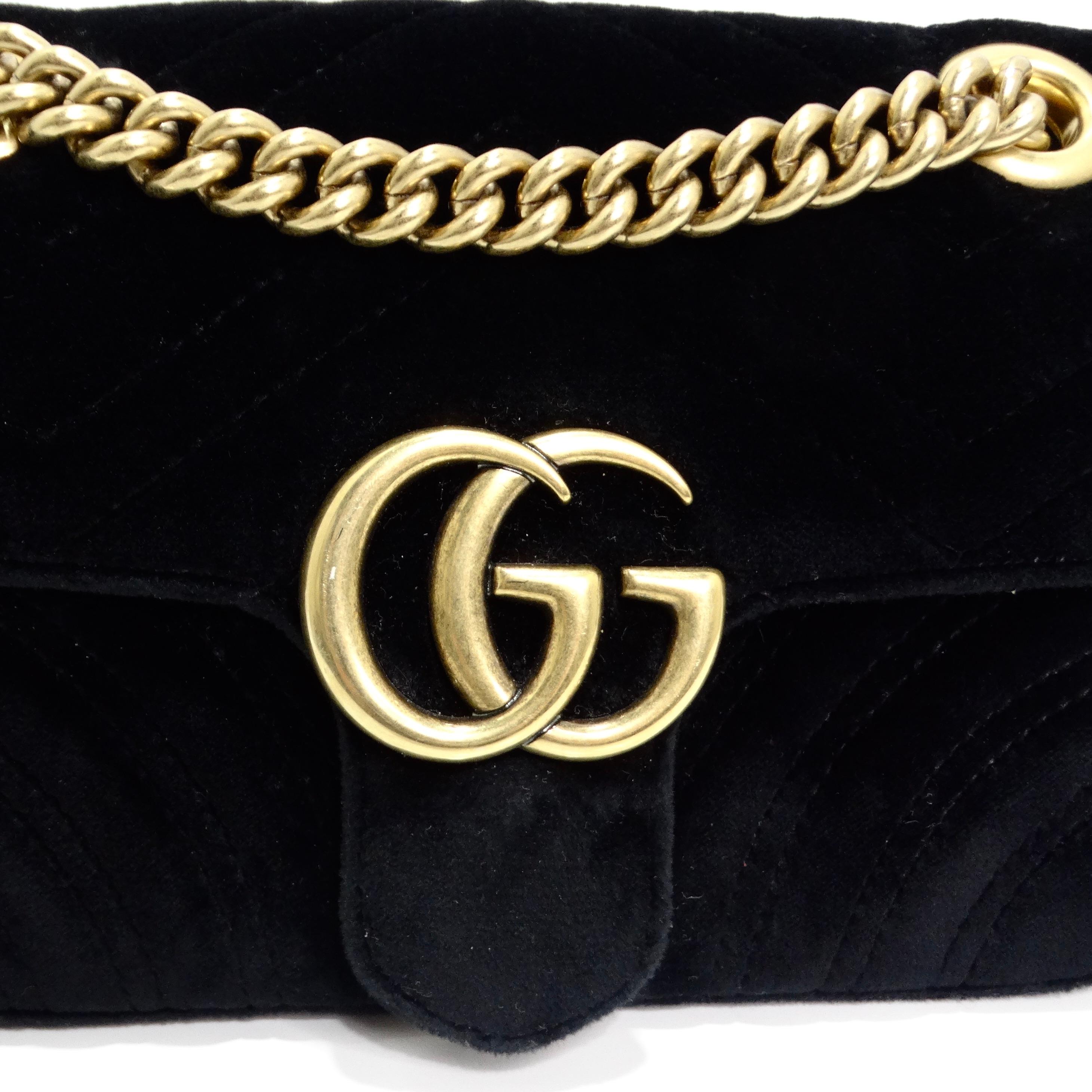 The Gucci Velvet Matelasse Mini GG Marmont Shoulder Bag in Black is a refined and luxurious accessory that combines elegance with modern flair. Crafted from soft quilted velvet in a timeless black hue, the bag exudes sophistication. The heart