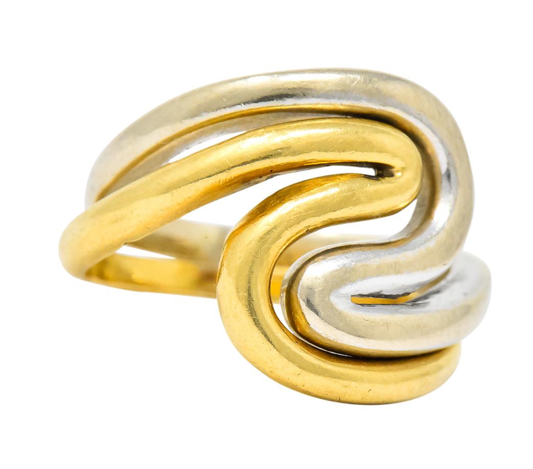 Designed as two interlocking wave shaped rings, one yellow gold and the other white gold

Each fully signed Gucci and stamped 750 for 18 karat gold

White gold ring size: 3 1/2

Yellow gold ring size: 3 3/4

Top measures: 14.0 mm and sits 1.6 mm