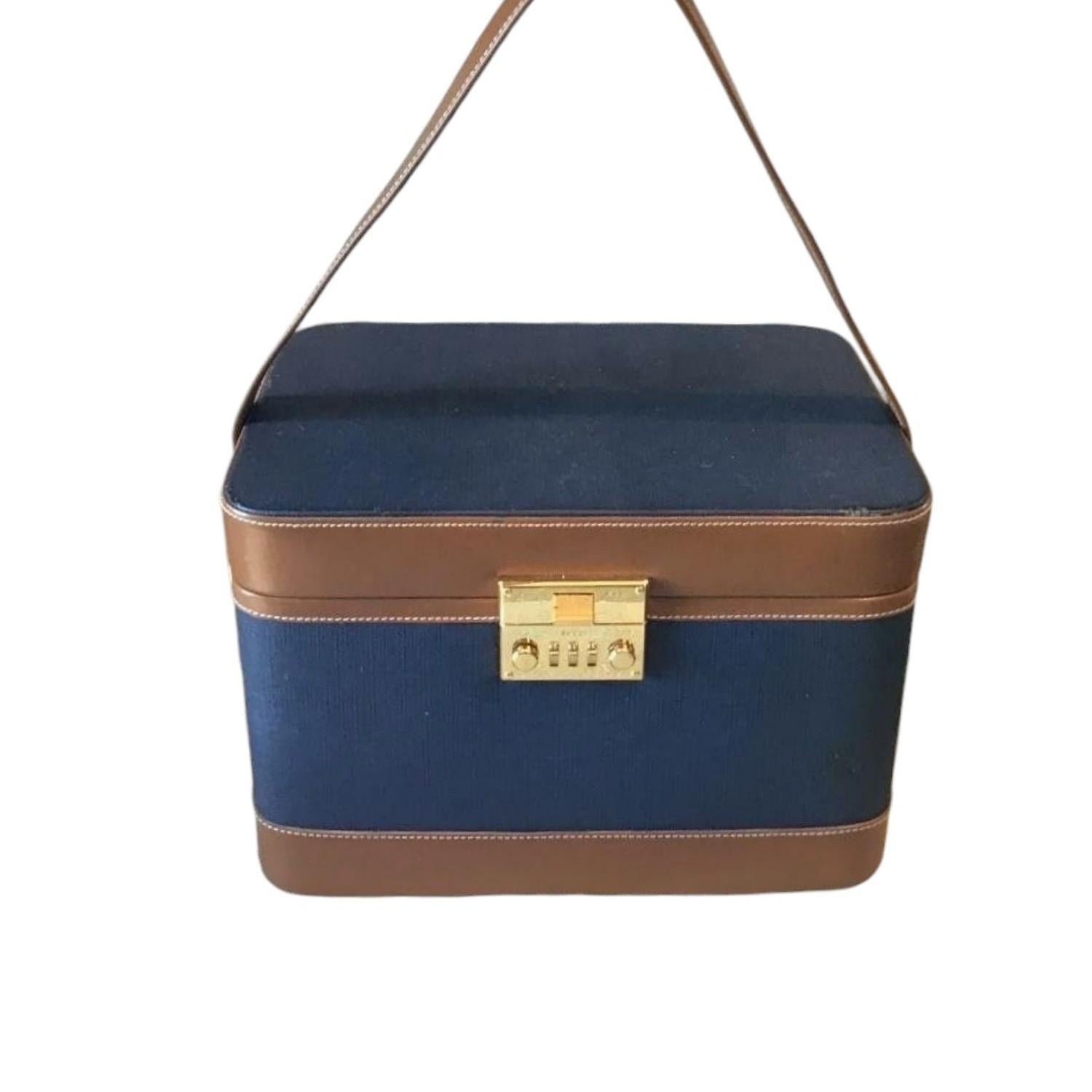 Take a step back in time with this stunning vintage Gucci beauty case from the 1970s. Meticulously crafted in Italy, this exquisite travel bag combines functionality with classic style. The exterior is a beautiful blend of deep blue-grained leather