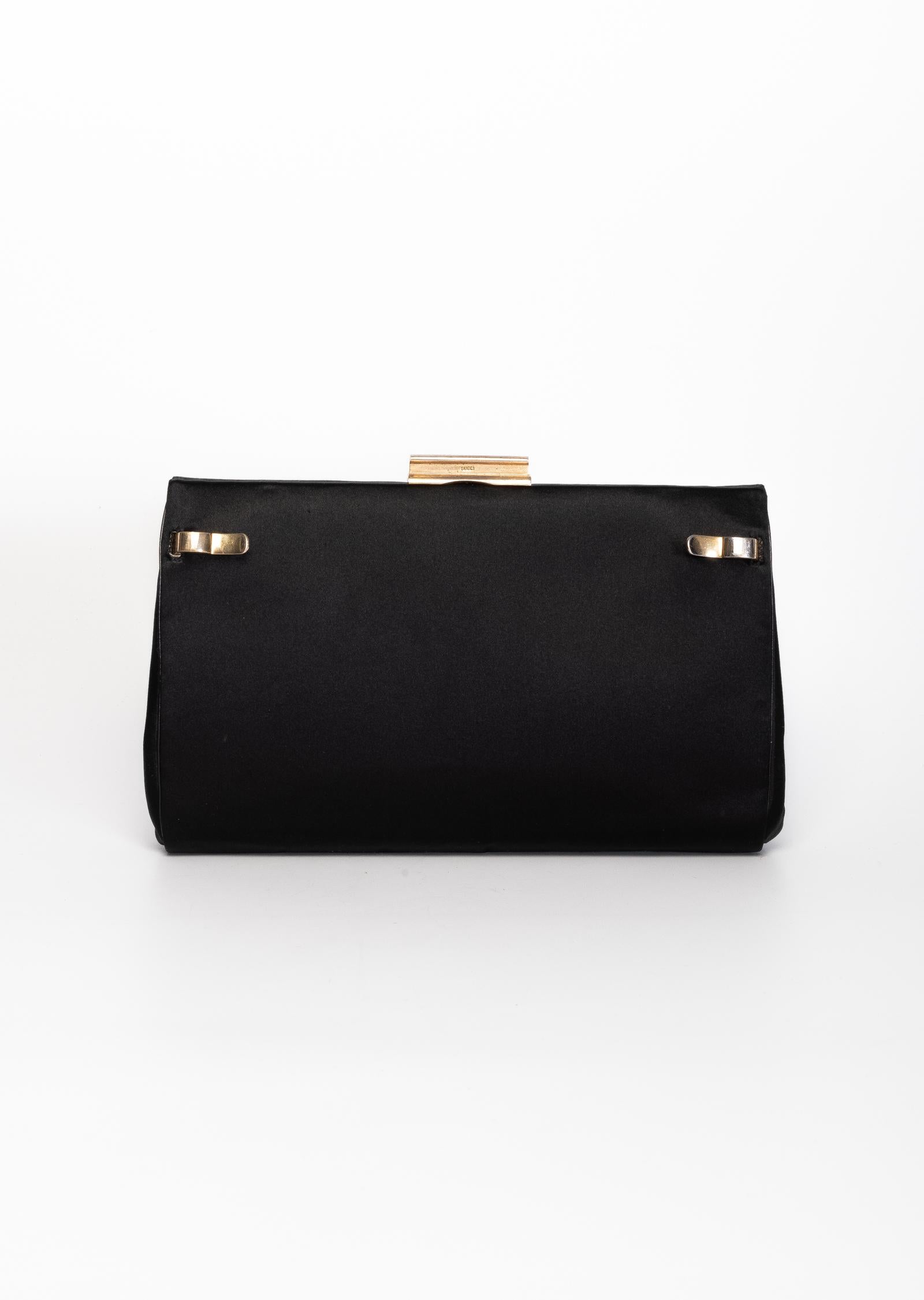 This 1970's Gucci 2N1 bag is convertible from a day shoulder bag to an evening clutch. For clasps open to remove the leather exterior to reveal an evening satin clutch. Featuring gold tone hardware, latch closure, silk linking & 2 slip pockets & a