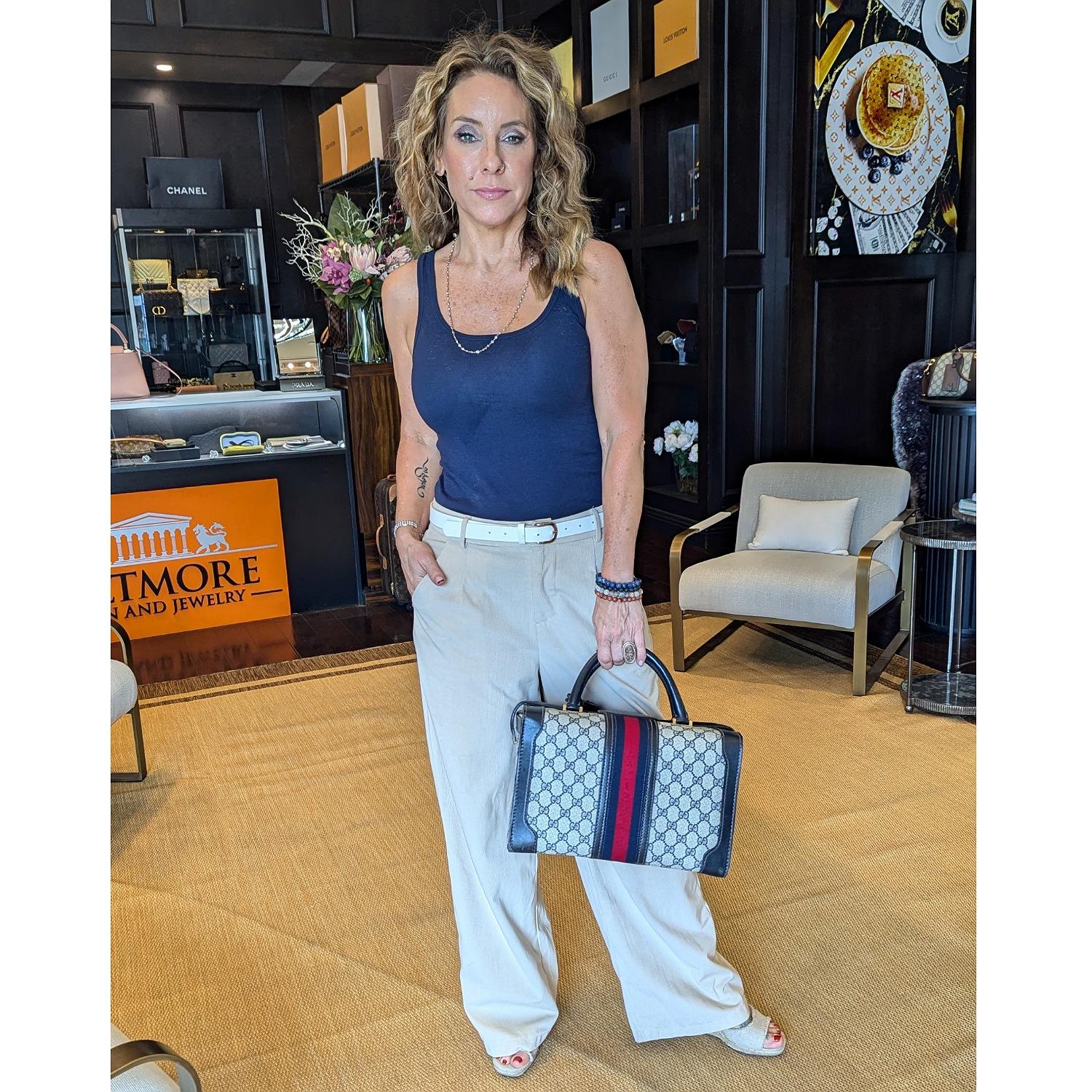 Indulge in luxury with the rare Vintage Gucci 3-lock train case travel bag. Chic and sophisticated, it can also double as a handbag. The leather clochette and brass keys add an elegant touch, while the interior lined with tan leather exudes timeless