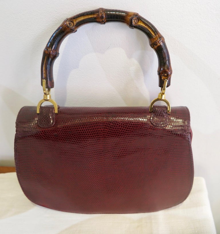 This iconic handbag is one of the most famous recognizable design by Gucci from ca. 1960.
Handbag in burgundy snakeskin with bamboo handle and gold foil mark 