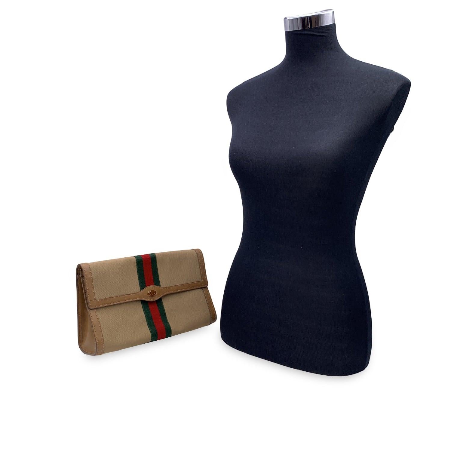 Gucci Vintage flap cosmetic bag with stripes. Beige canvas with genuine leather trim. Green/Red/Green stripes around the bag. GG - GUCCI logo on the front. Flap with button closure on the front. Beige lining. 'GUCCI Parfums- Made in Italy' tag