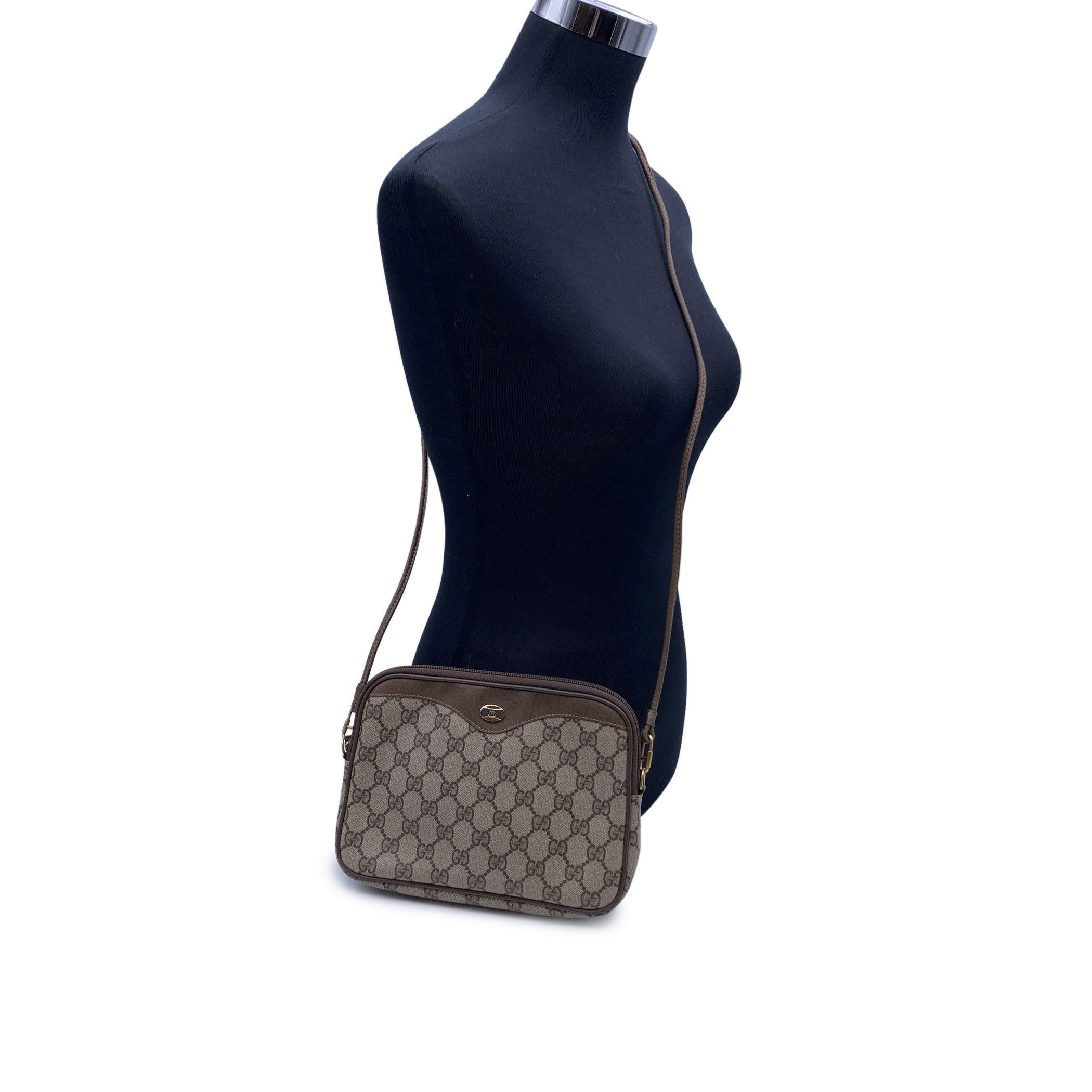 Beautiful Vintage Gucci crossbody bag made in monogram canvas with tan leather trim. Gold metal GG - GUCCI logo on the front. Upper zipper closure. Canvas lining. Removable shoulder strap. 'GUCCI Accessory collection - Made in Italy' tag inside