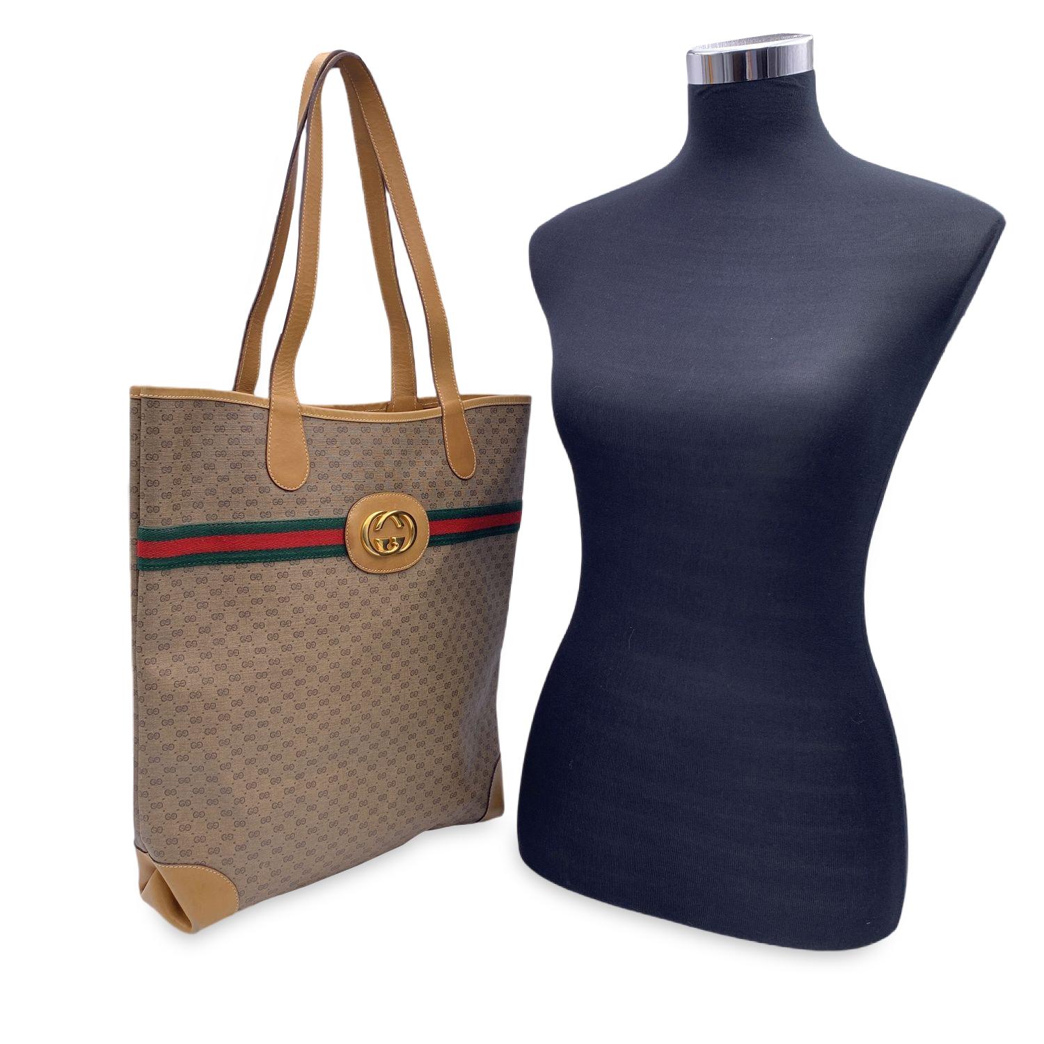 Vintage Gucci beige monogram canvas tote shopping bag with green/red/green striped detailing. Beige leather trim. Gold metal GG - GUCCI logo on the front. Open top. Beige lining. 'Gucci - Made in Italy' tag (with serial number on its