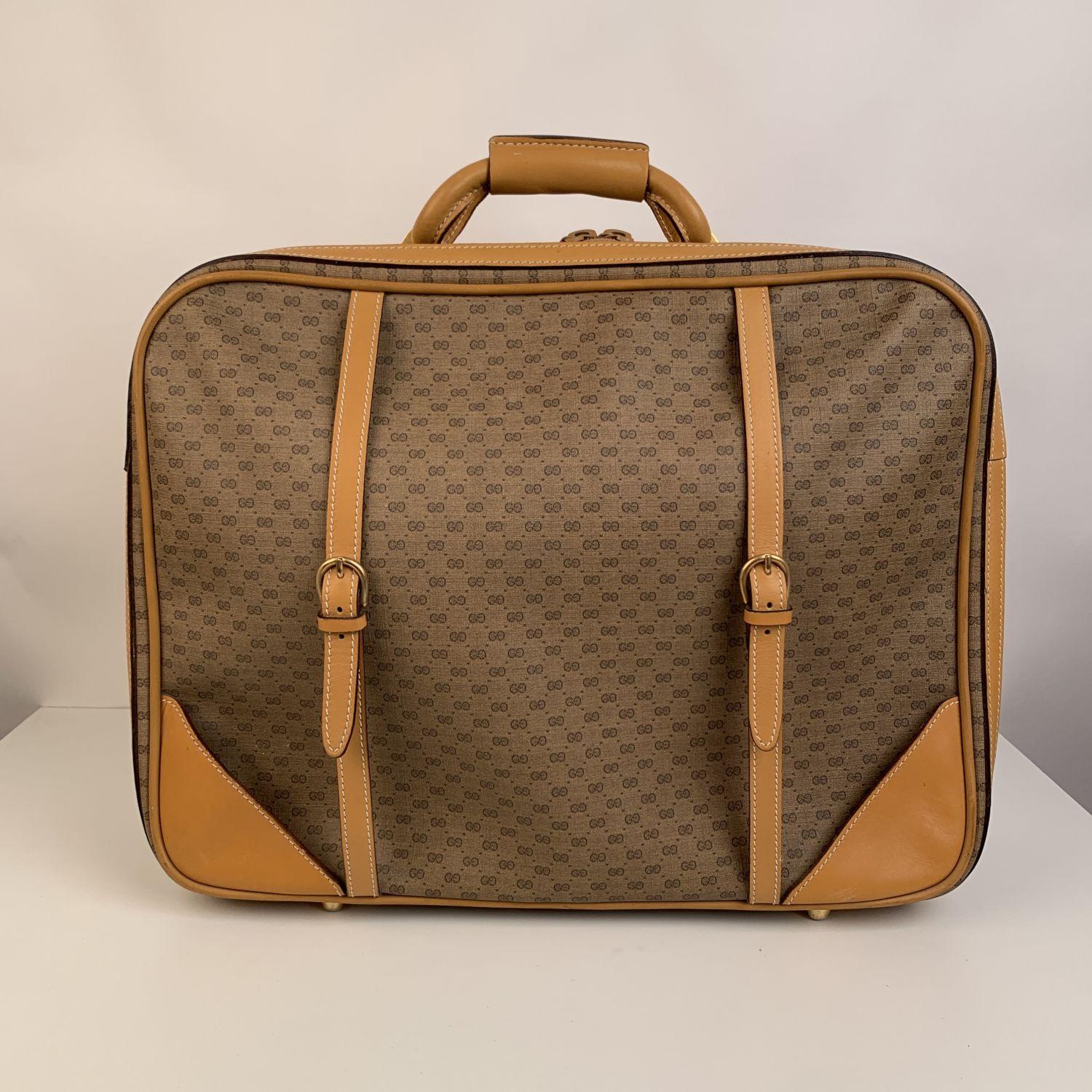 Gucci Vintage Beige Monogram Canvas Cabin Size Travel Bag. GG -GUCCI monogram canvas & Genuine leather trim. Wrap-around dual zipper closure. Gold metal hardware. 4 bottom feet. Canvas lining. 1 main compartment with dual straps for securing