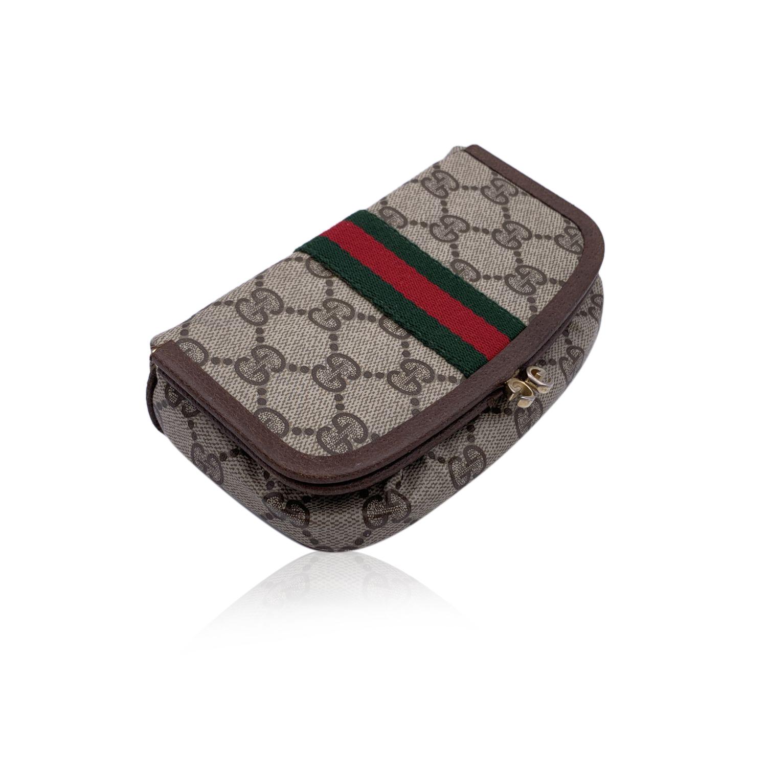 Gucci Vintage beige monogram canvas cosmetic case stripes. Beige Monogram Canvas with Genuine Leather trim. Green/Red/Green stripes around the bag. Buit-in mirror inside. Kiss lock closure. Brown lining. 