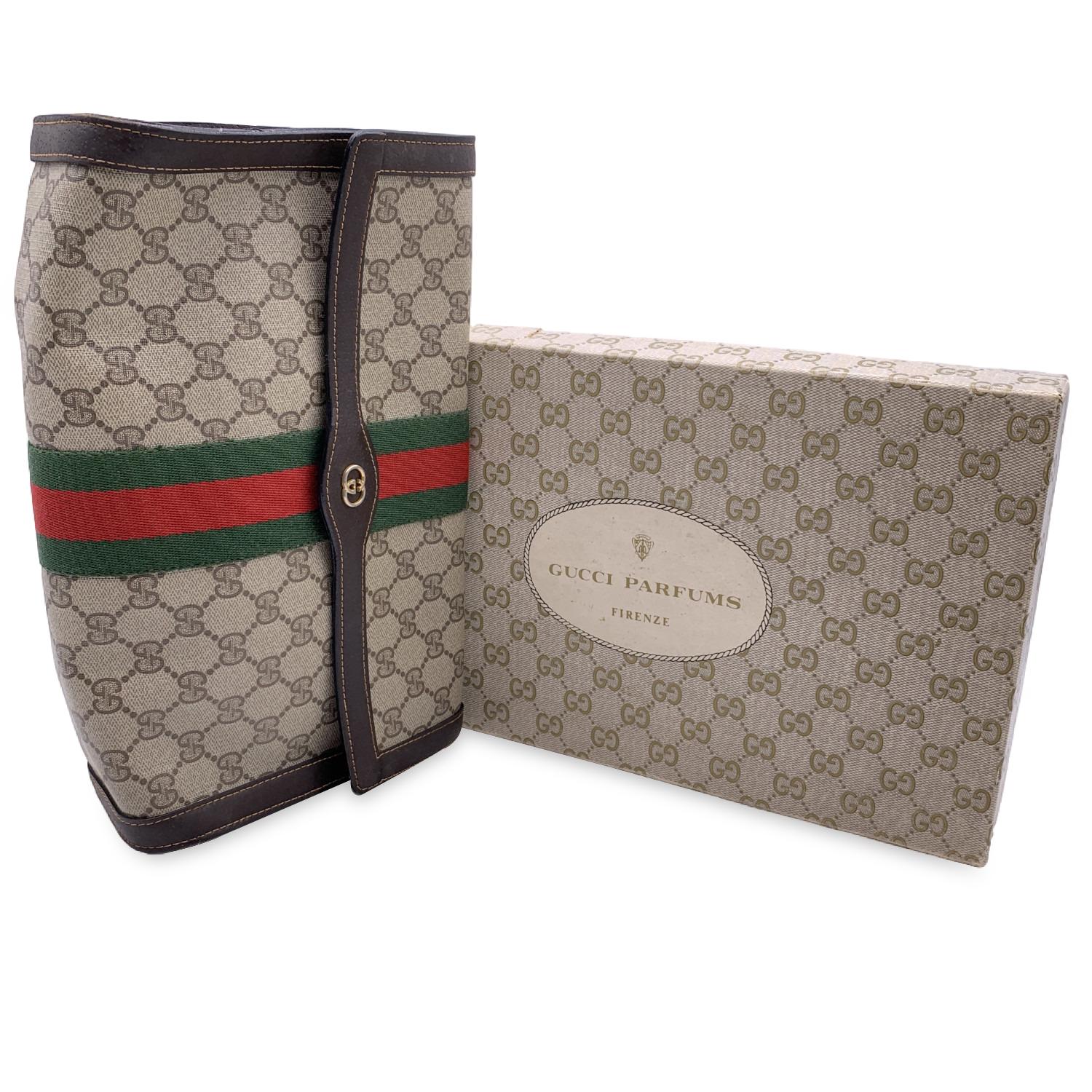 Gucci Vintage flap cosmetic bag with stripes. Beige monogram canvas with Brown genuine Leather trim. Green/Red/Green stripes around the bag. Gold metal GG - GUCCI logo on the front. Flap with button closure on the front. Waterproof lining. 'GUCCI