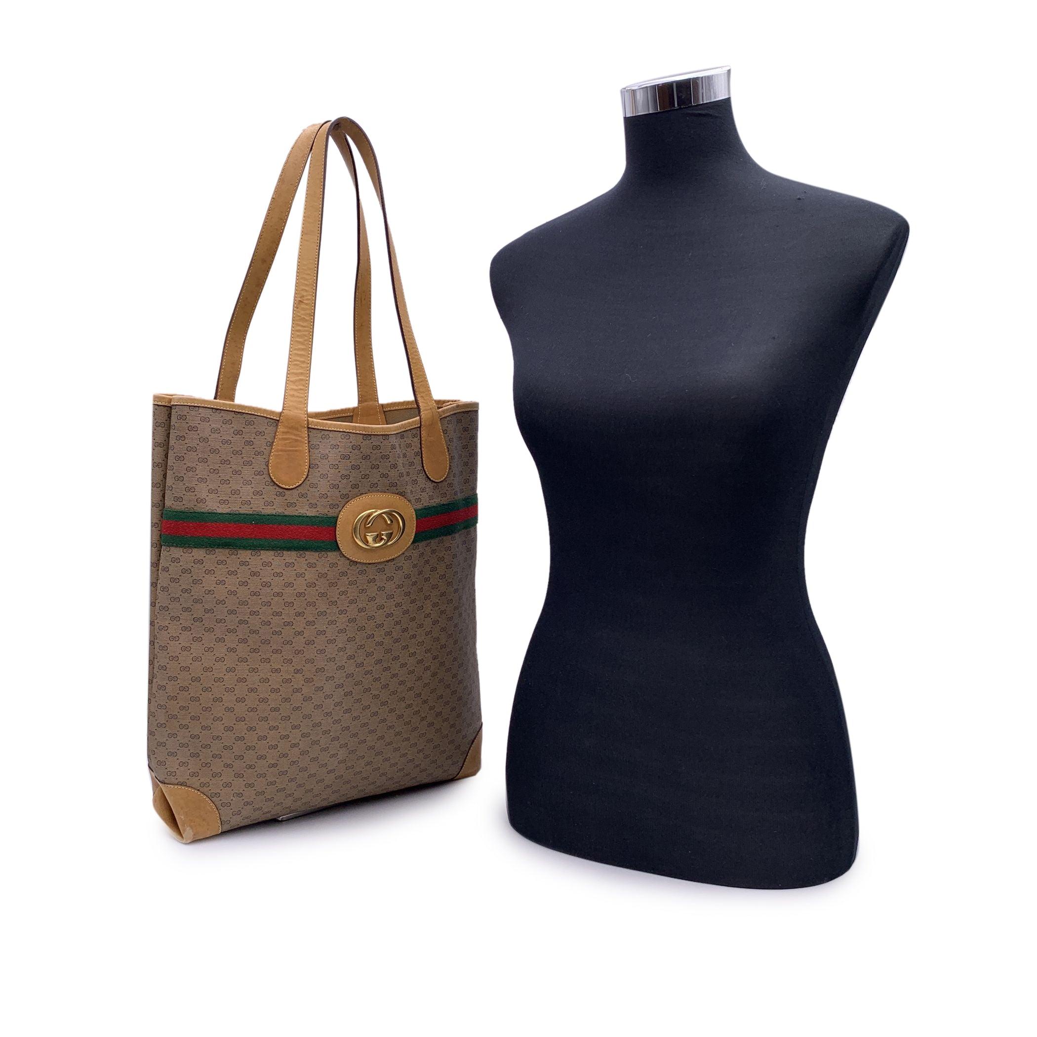 Embrace a blend of vintage charm and iconic Italian craftsmanship with this timeless Gucci Beige Monogram Canvas Tote Shopping Bag. This classic piece exudes effortless sophistication, crafted from the brand's signature beige monogram canvas. The