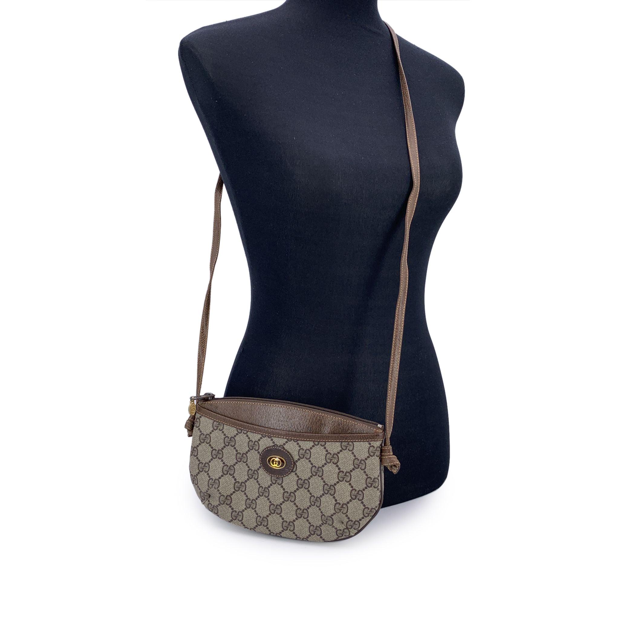 Charming and compact, this Small Vintage Gucci Monogram Beige Canvas Messenger Bag is a delightful piece from the Gucci Accessory Collection, echoing the effortless style of decades past. Crafted in signature GG monogram canvas, it's finished with