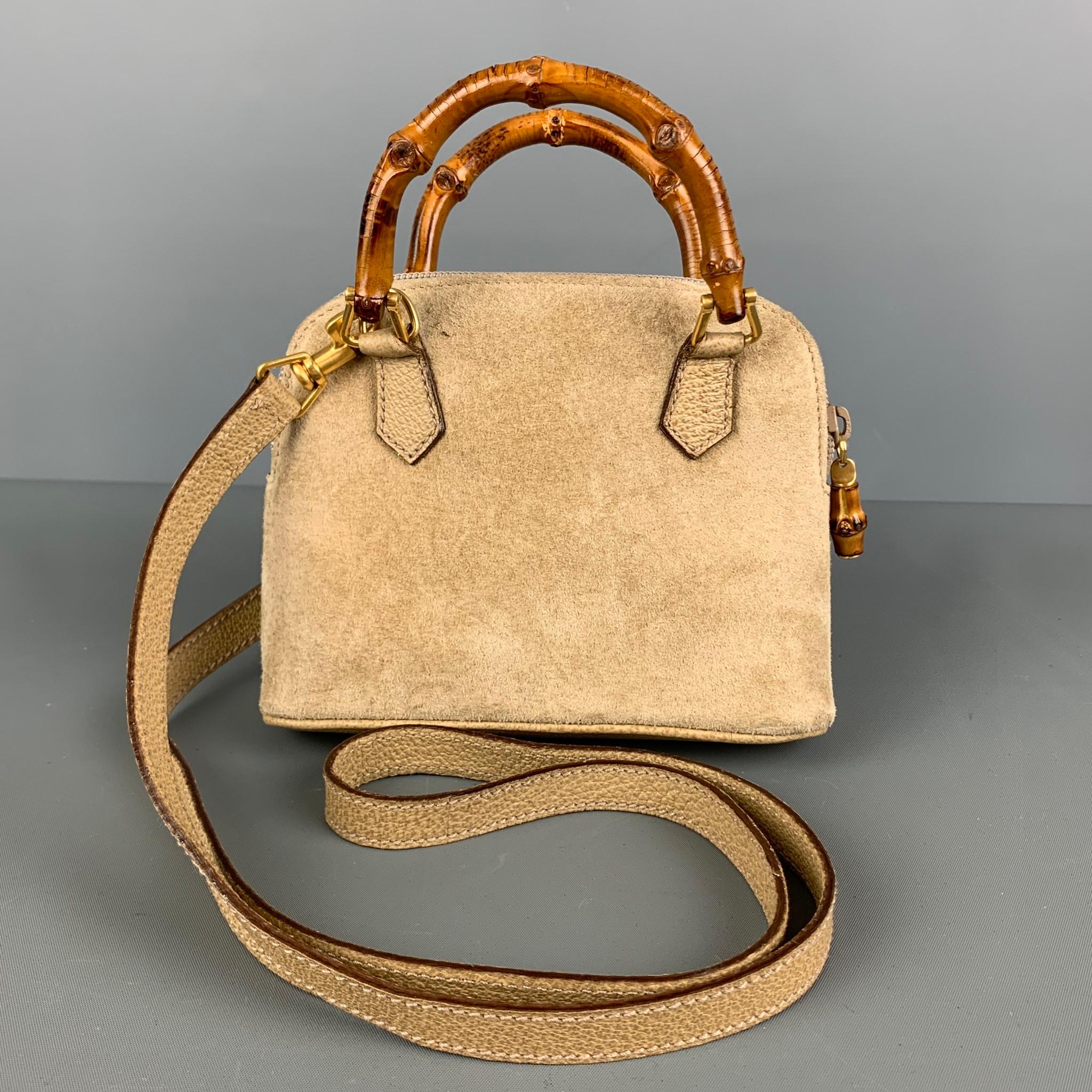 GUCCI mini crossbody bag comes in beige suede leather featuring a removable shoulder strap, inner zipper pocket, bamboo handle, and zipper closure. Comes with dust Bag. Made in Italy.

Very Good Pre-Owned Condition. Minor signs of