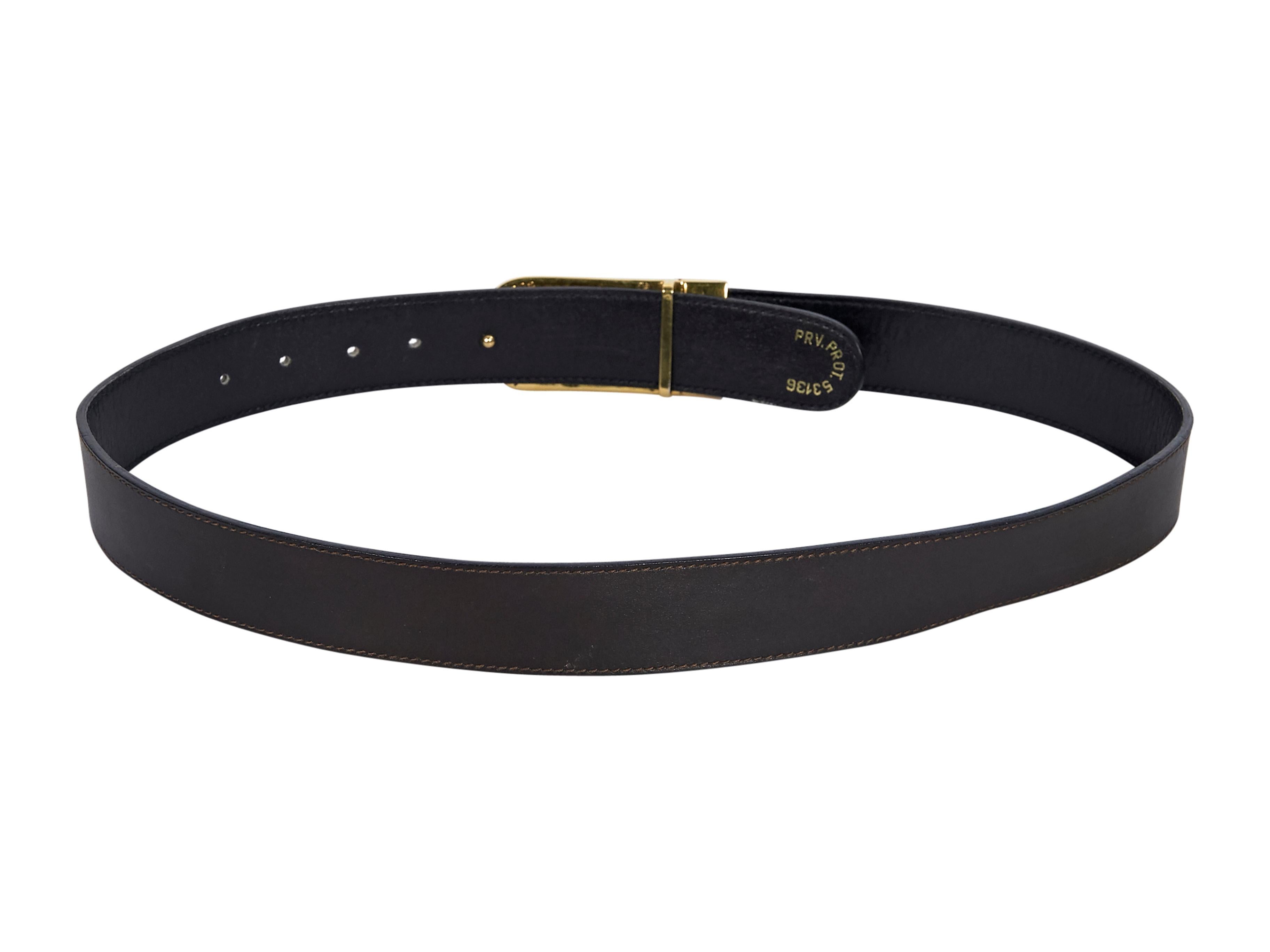 Product details: Vintage black and brown reversible leather belt by Gucci.  Adjustable gold-tone and silver-tone horsebit pin buckle closure. Gold-tone hardware. Pair with tailored pants. 21.5