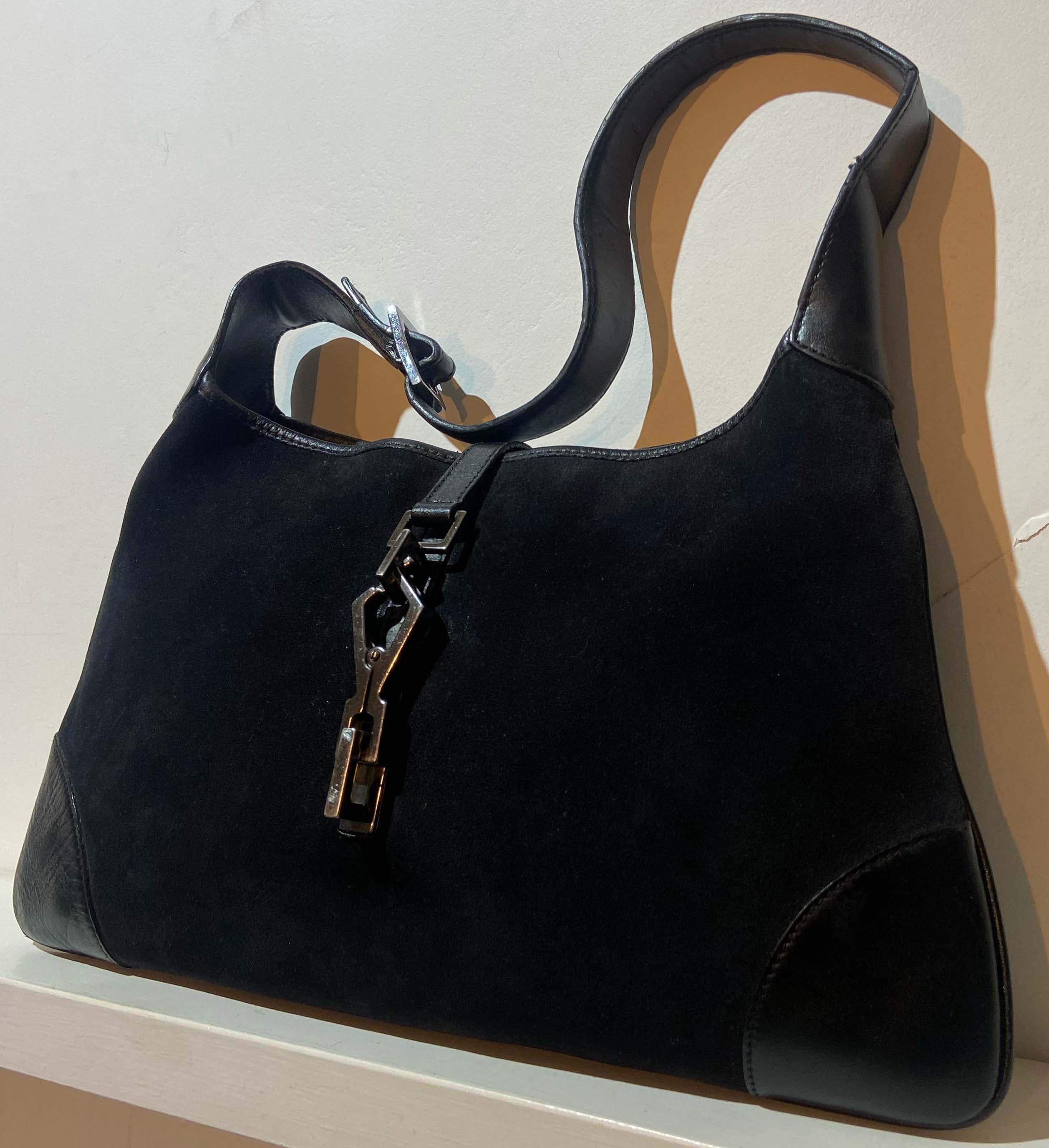 Vintage Gucci Jackie shoulder bag. Features a leather handle and a black suede canvas. Back interior zip pocket and fastens with front clip silver hardware.  In excellent vintage condition. 

Brand: Gucci
Color: Black

Fabric: Suede/Leather
Year /