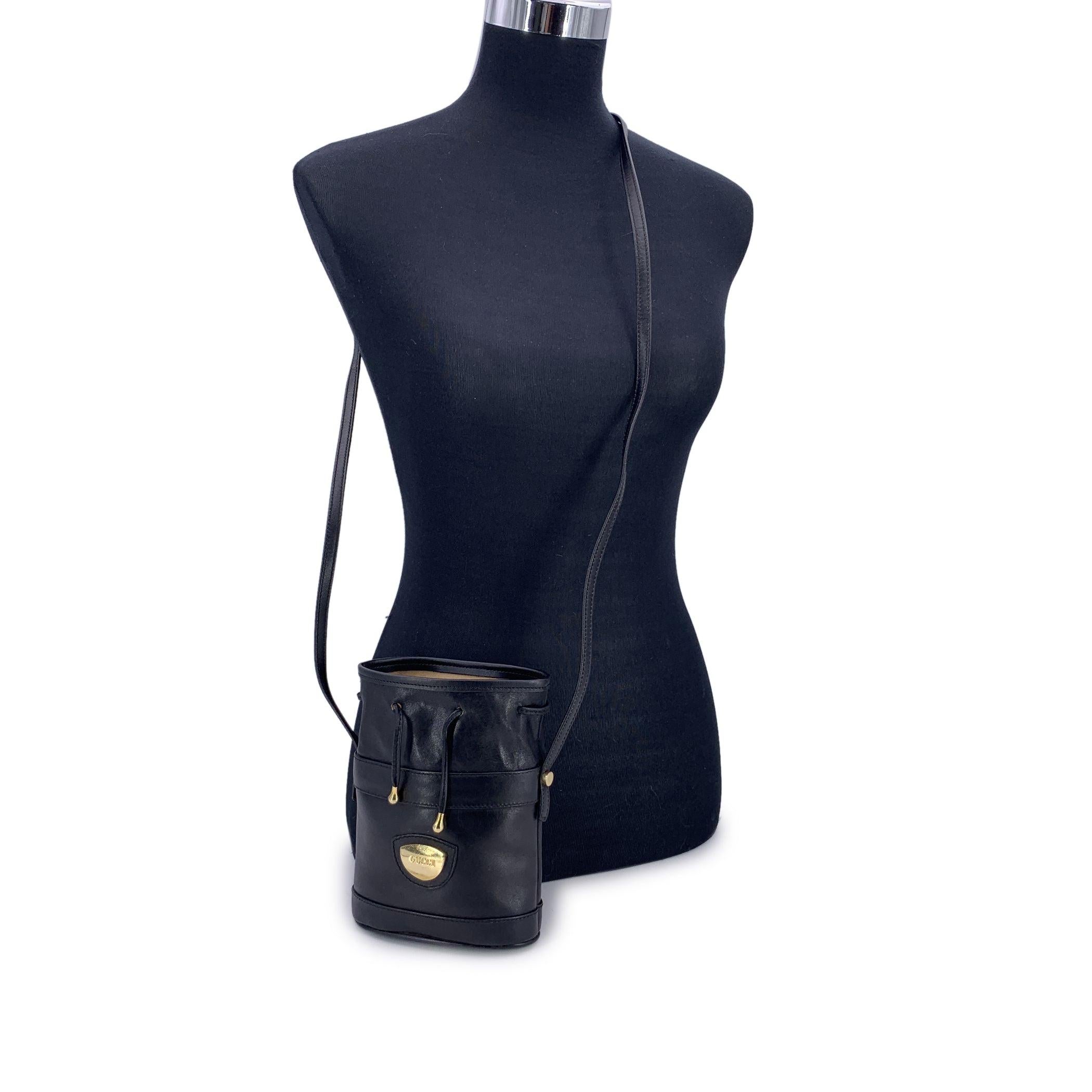 A true gem for lovers of vintage luxury, this Gucci mini drawstring bucket bag in supple black leather is a timeless piece that speaks to the quiet elegance of early-era Gucci. Its compact silhouette is accentuated by a classic drawstring closure,