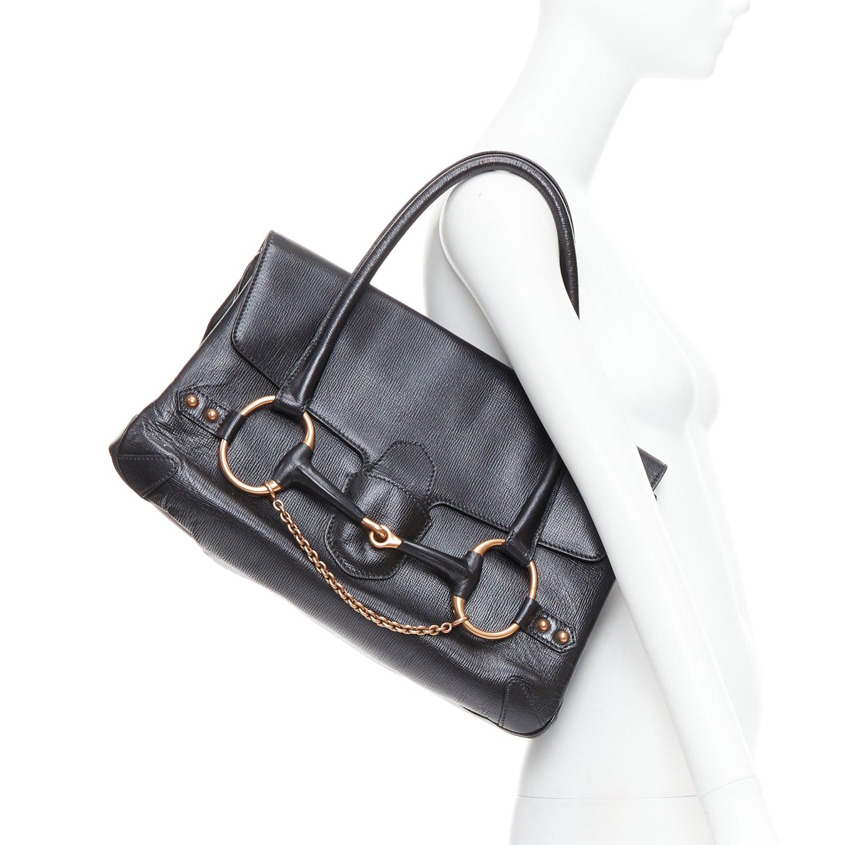 GUCCI Vintage black leather gold horsebit chain tote bag
Reference: TGAS/E00499
Brand: Gucci
Designer: Tom Ford
Material: Leather
Color: Black, Gold
Pattern: Solid
Closure: Loop Through
Lining: Black Fabric
Extra Details: GUCCI Leather Large