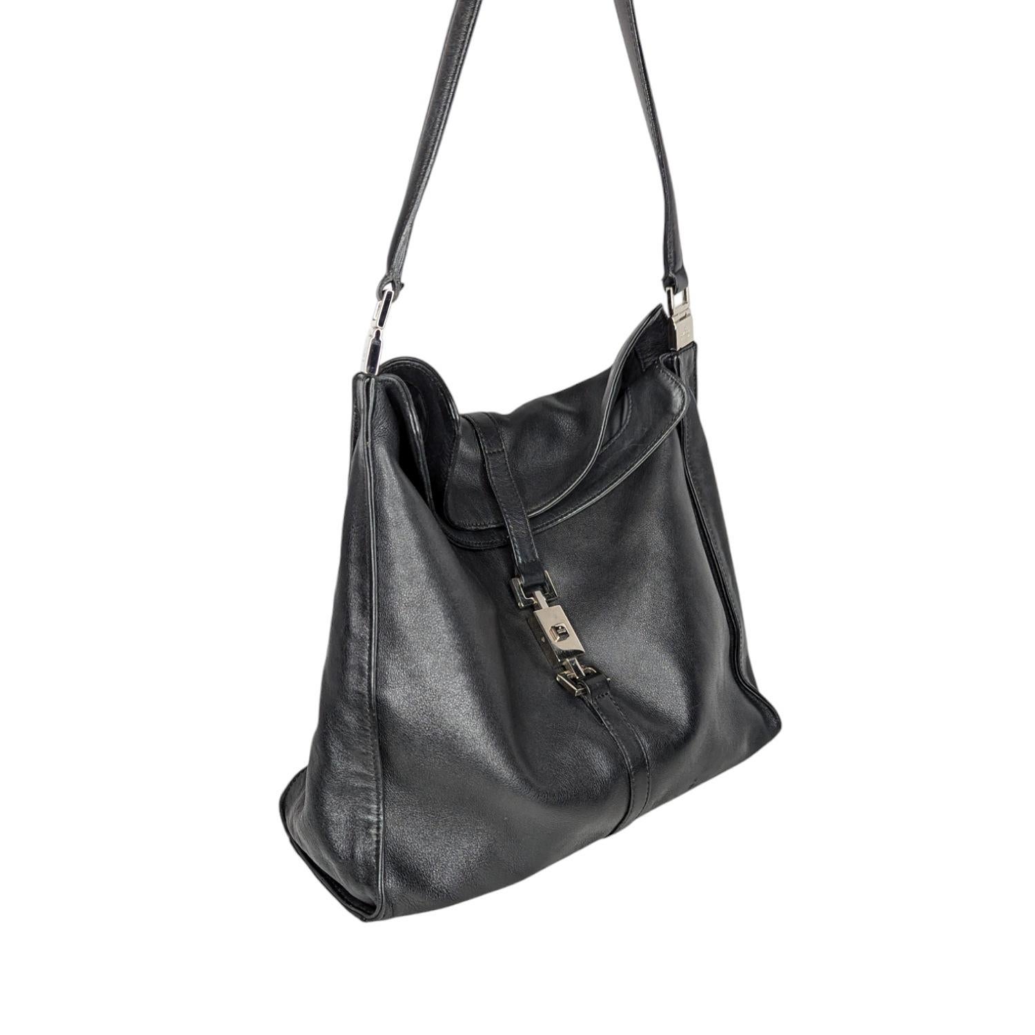 This stylish vintage Gucci Hobo is crafted of soft genuine leather in black with polished silver-tone hardware. It features a single shoulder strap, a piston accent push-lock closure at front, a spacious interior with Gucci logo jacquard Lining and