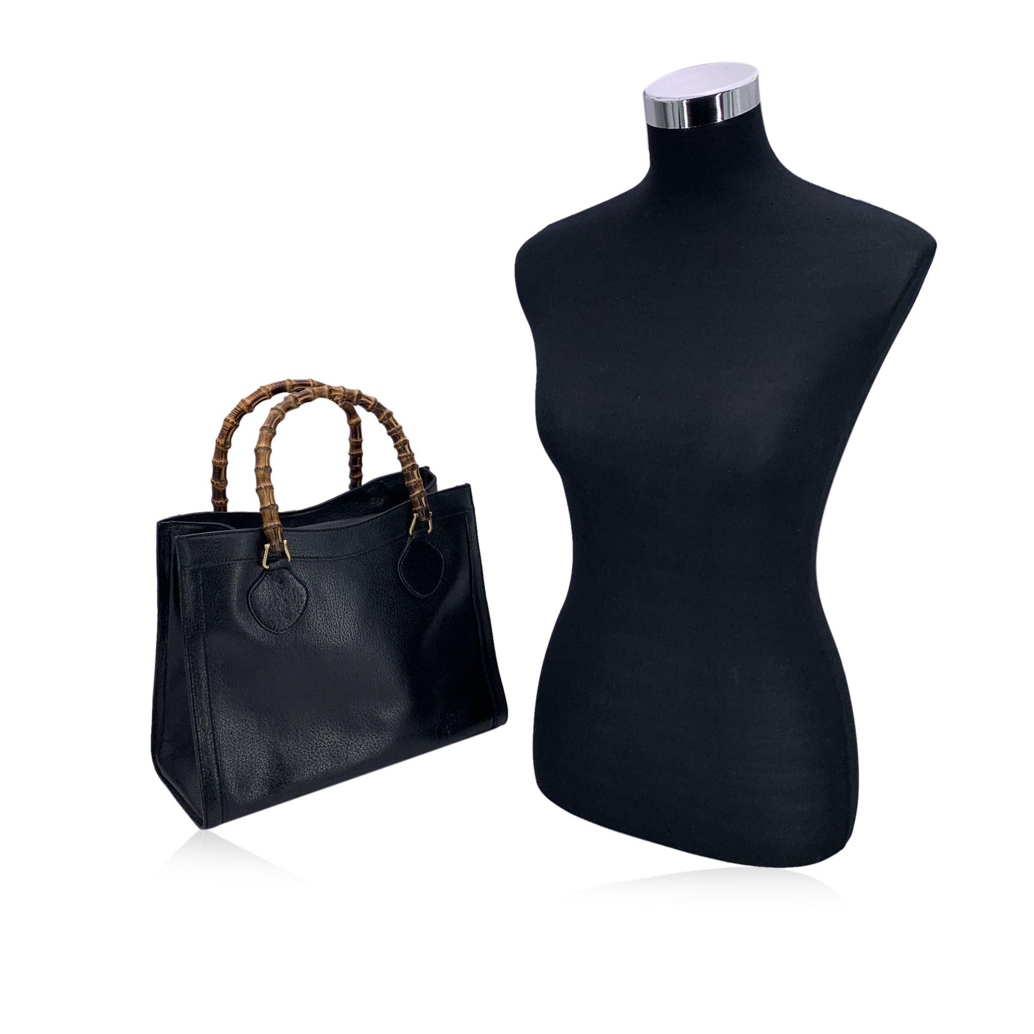 Step into the world of timeless elegance with this beautiful Gucci Diana Bamboo tote bag in classic black leather. Featuring the signature double bamboo handles, this bag is a true symbol of luxury, its iconic design evoking memories of the past.