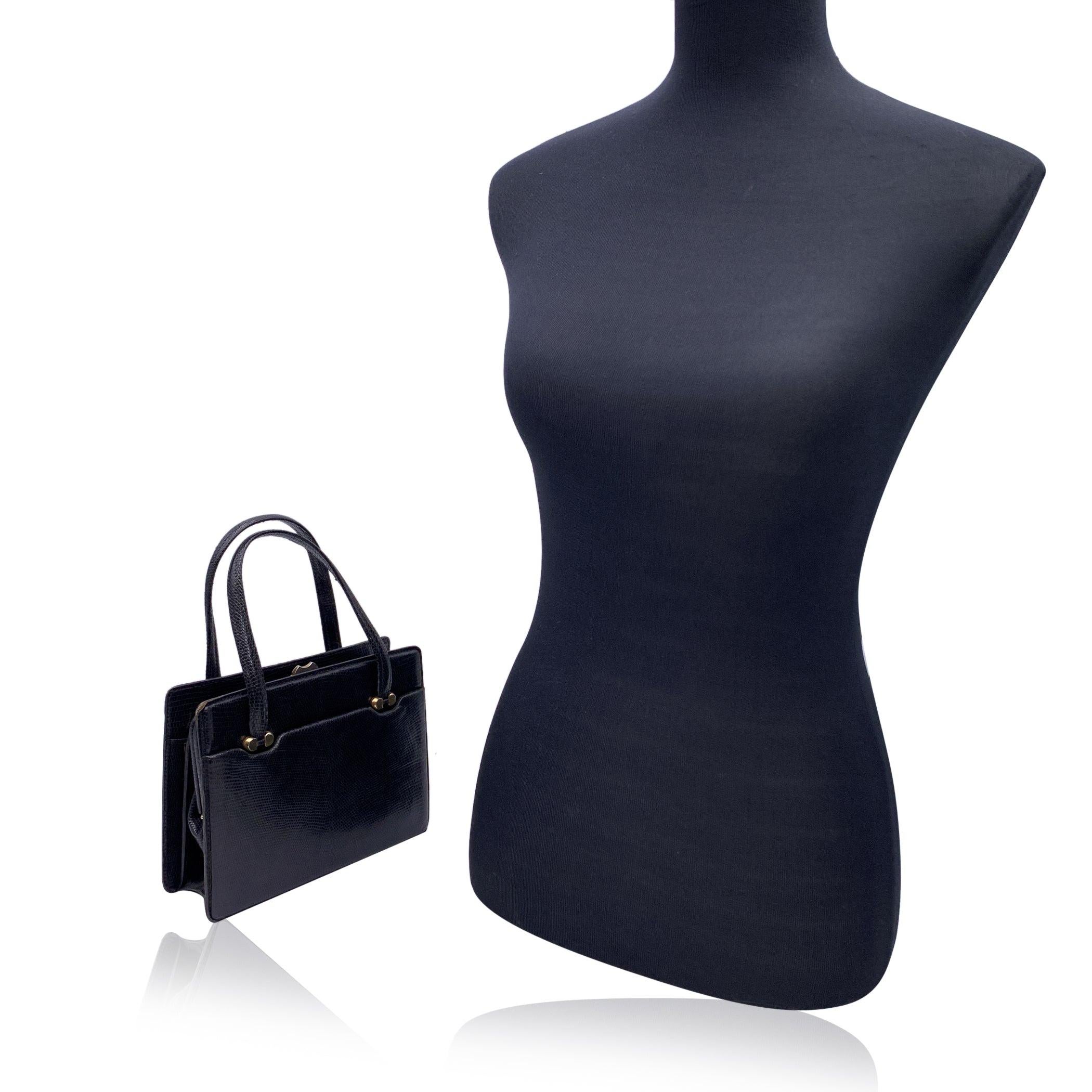 Beautiful Vintage Gucci handbag made in black leather. Doubel top carry handle. Framed main compartment with clasp closure. 2 open pockets on the front and 2 open pockets on the back. Black leather interior. 1 side zip pocket and 3 side open pockets