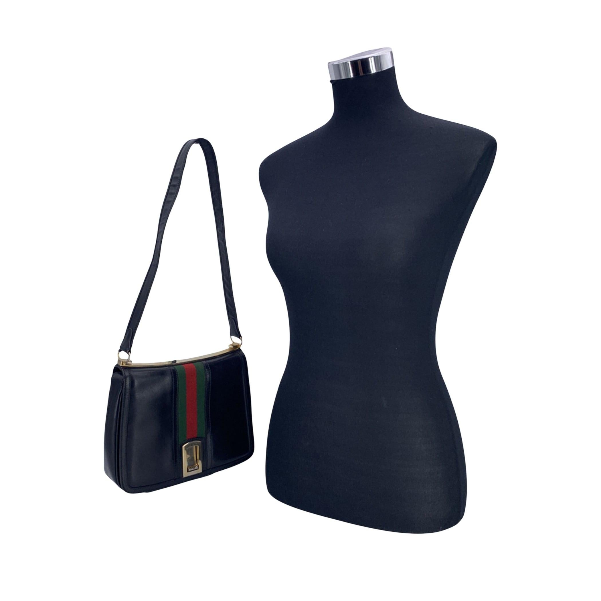 This vintage Gucci Shoulder Bag is a stunning example of timeless style and luxury craftsmanship. Made from rich black leather, this bag exudes sophistication while offering a nod to Gucci's iconic design elements. The front of the bag are adorned