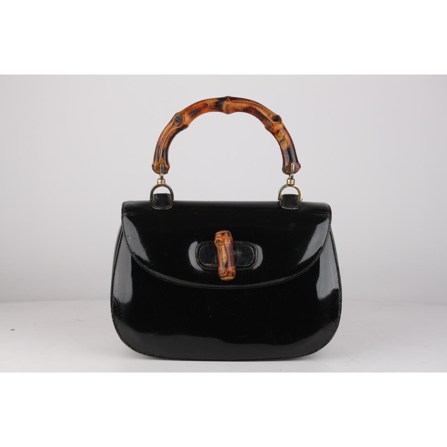 Gucci Vintage Black Patent Leather Bamboo Top Handle Bag

Material: Patent Leather 
Color: Black
Model: Bamboo Bag
Gender: Women
Country of Manufacture: Italy
Size: Small Bags
Bag Depth: 3.5 inches - 8,9 cm 
Bag Height: 7 inches - 17,8 cm 
Bag