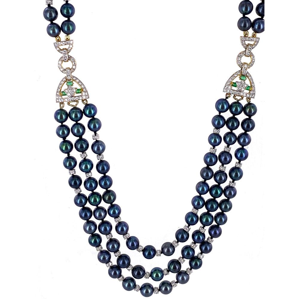 Stunning vintage Gucci black pearl, diamond, and emerald necklace. This fabulous estate piece features 7.5mm cultured black pearls, round brilliant cut white diamonds, and green emerald accents. Hand crafted in 18 karat yellow gold, the necklace