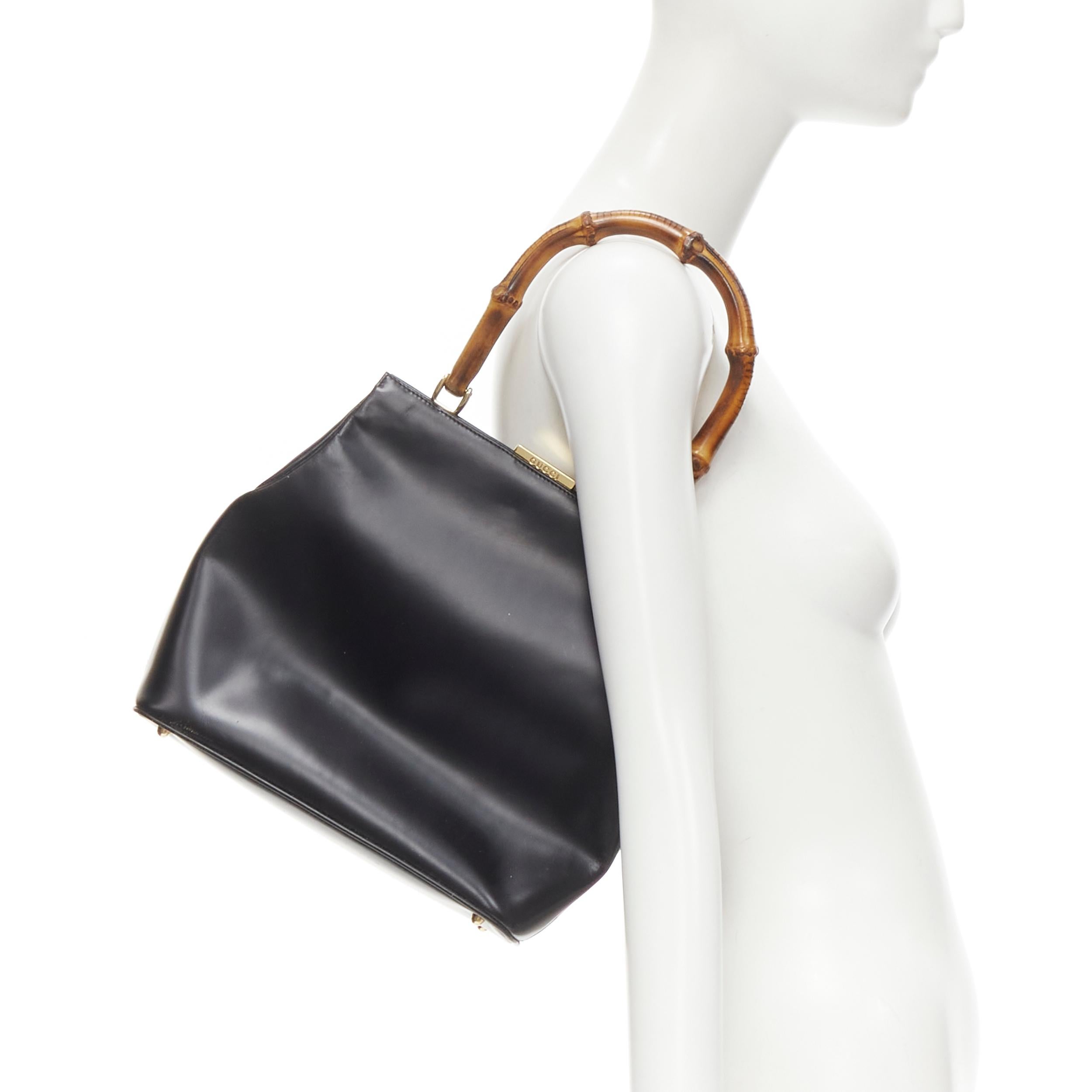 GUCCI Vintage black smooth leather Bamboo top handle structured bag 
Reference: GIYG/A00238 
Brand: Gucci 
Material: Leather 
Color: Black 
Pattern: Solid 
Closure: Clasp 
Extra Detail: Gold-tone hardware. Bamboo handle. Smooth black leather. Zip