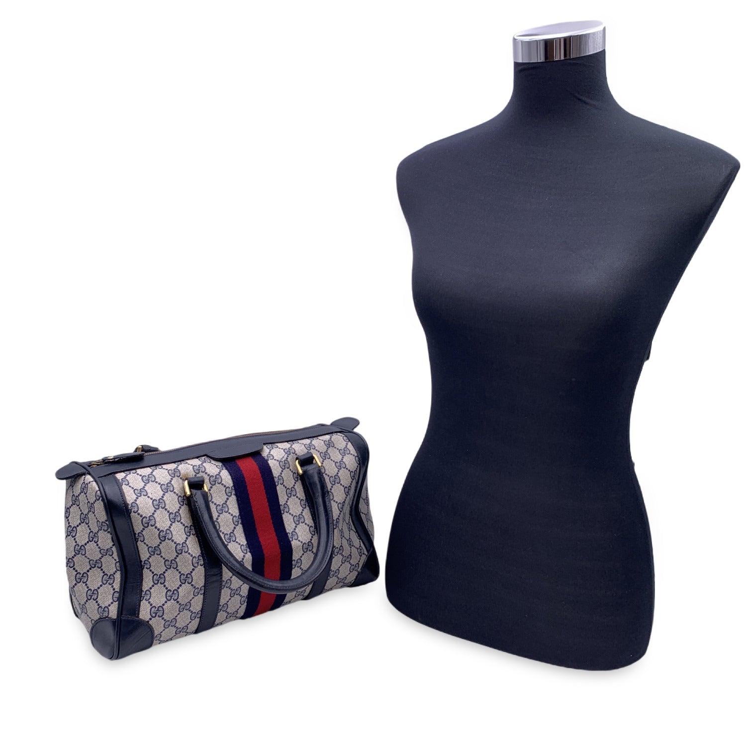 Double top handles. Upper zipper closure. 'Made in Italy by GUCCI' tag inside. Condition B - VERY GOOD Gently Used. A small mark on the front canvas. Some very light leather marks on the bottom corners. A small 