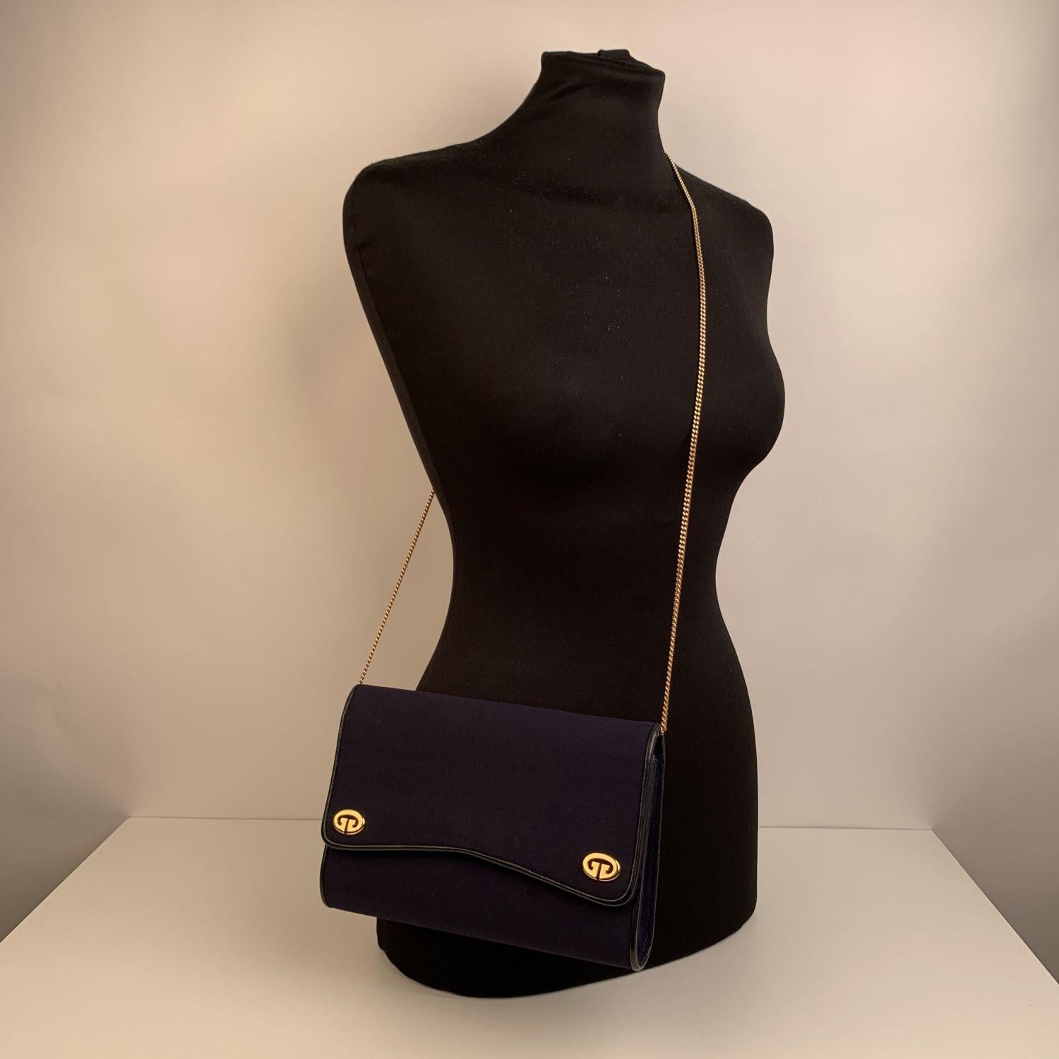 Vintage Gucci evening bag in blue fabric with genuine leather trim. Double gold metal GG - GUCCI logo on the front. Removable Gold metal chain shoulder strap (can be worn on the shoulder or with hand, as a clutch). Flap with double button closure.