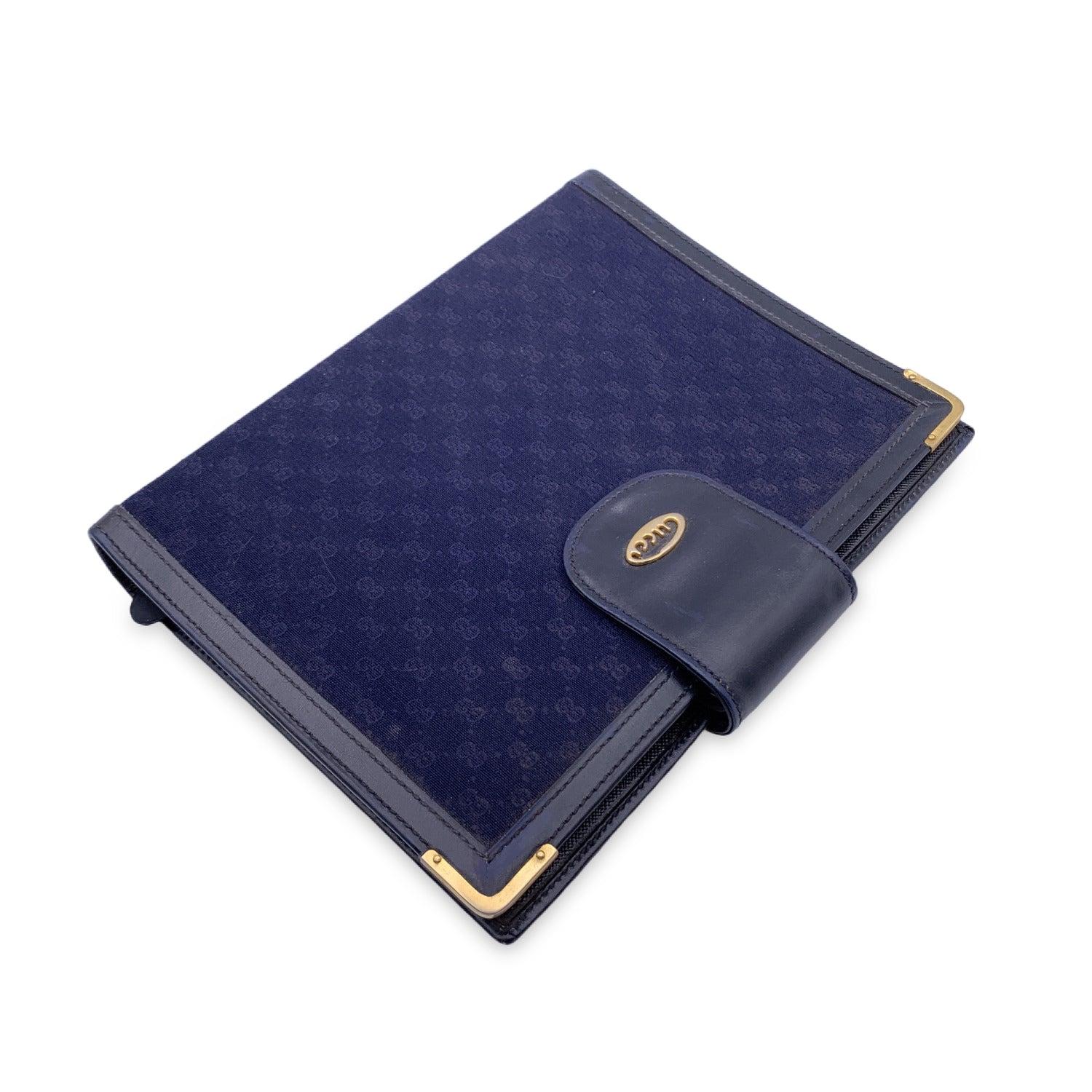Vintage Agenda cover by GUCCI. It features a 4 ring binder inside. 1 side open slot inside. Button closure. Leather interior. 'Made in Italy by GUCCI' stamper internally. Details MATERIAL: Cloth COLOR: Blue MODEL: n.a. GENDER: Unisex Adults COUNTRY