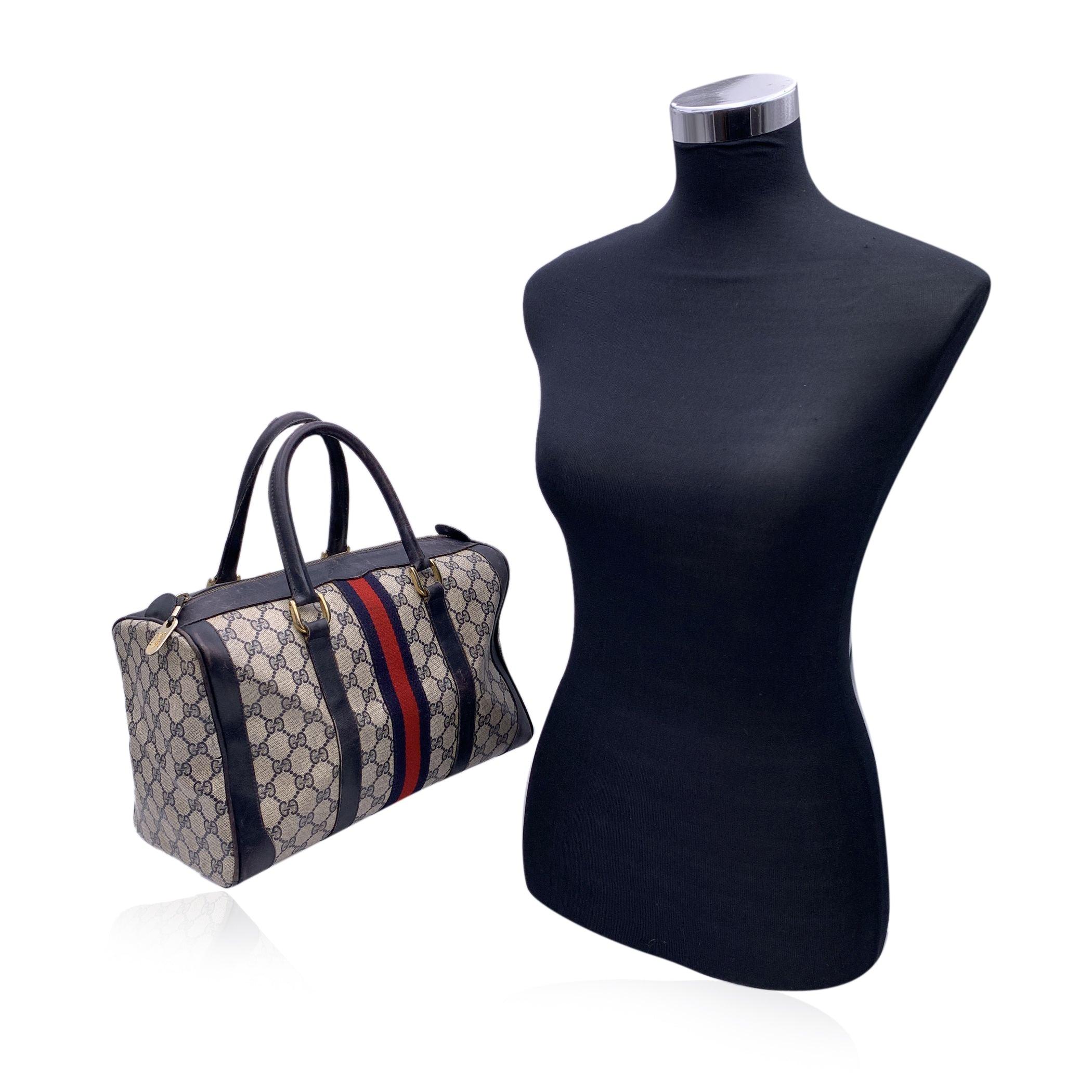 Step into a world of timeless luxury with the Gucci Vintage Blue Canvas and Leather Monogram Web Boston Bag, a piece that effortlessly blends heritage, craftsmanship, and style. This classic design features the iconic Gucci blue monogram canvas,